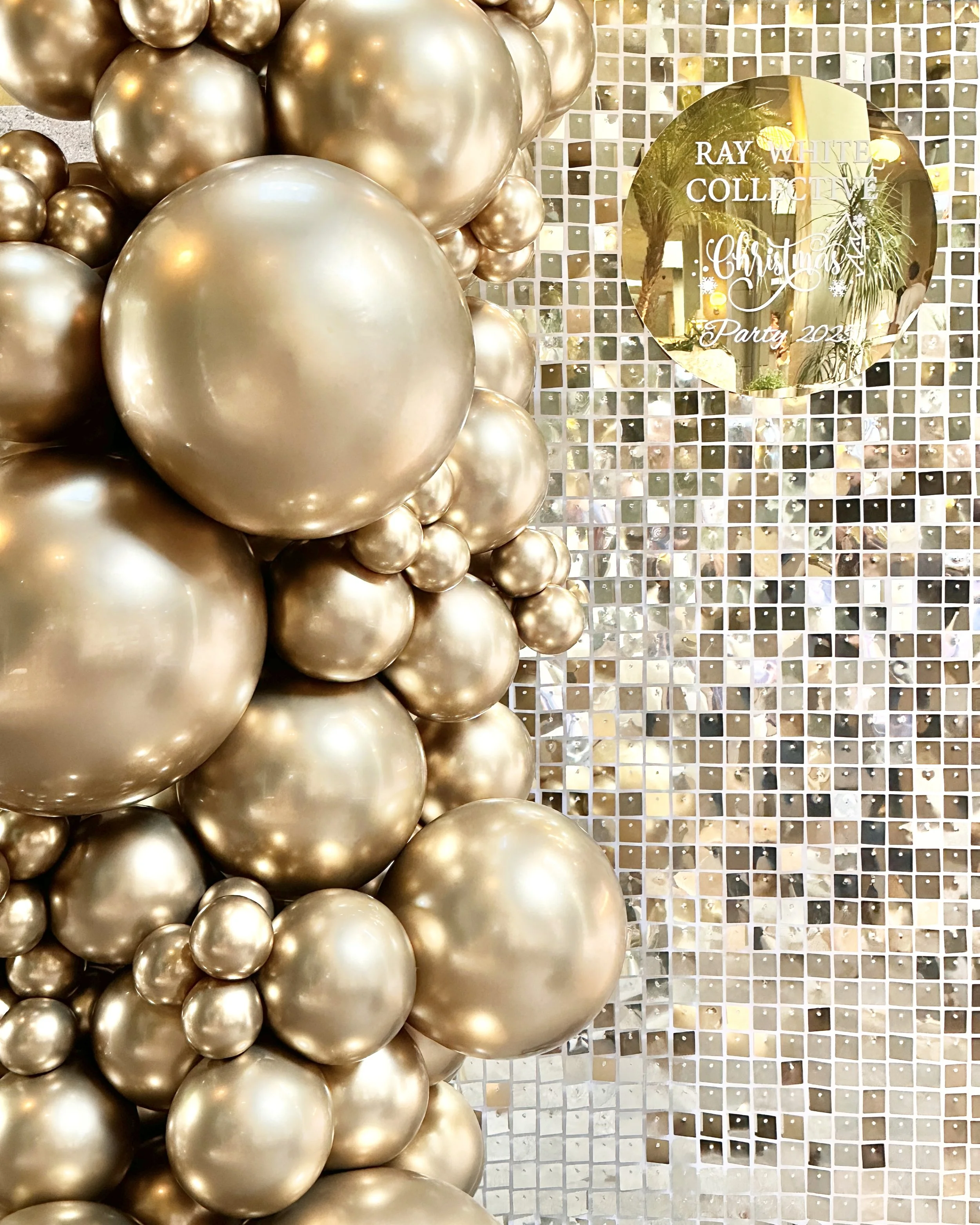 Gold shimmer wall with gold sign and gold balloons