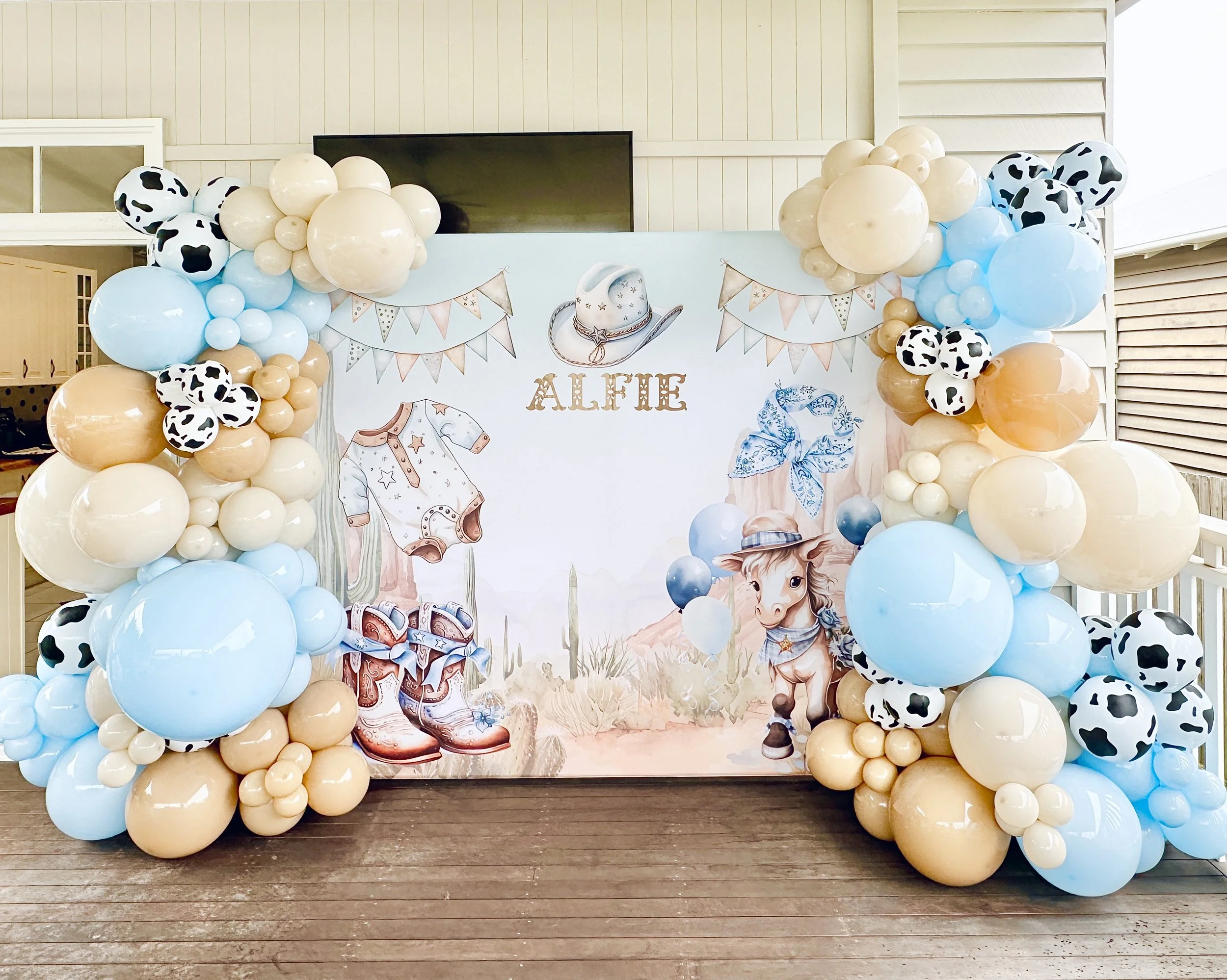 Decorative cowboy themed backdrop for a child's first rodeo birthday party or a Little Cowboy Is On The Way baby shower