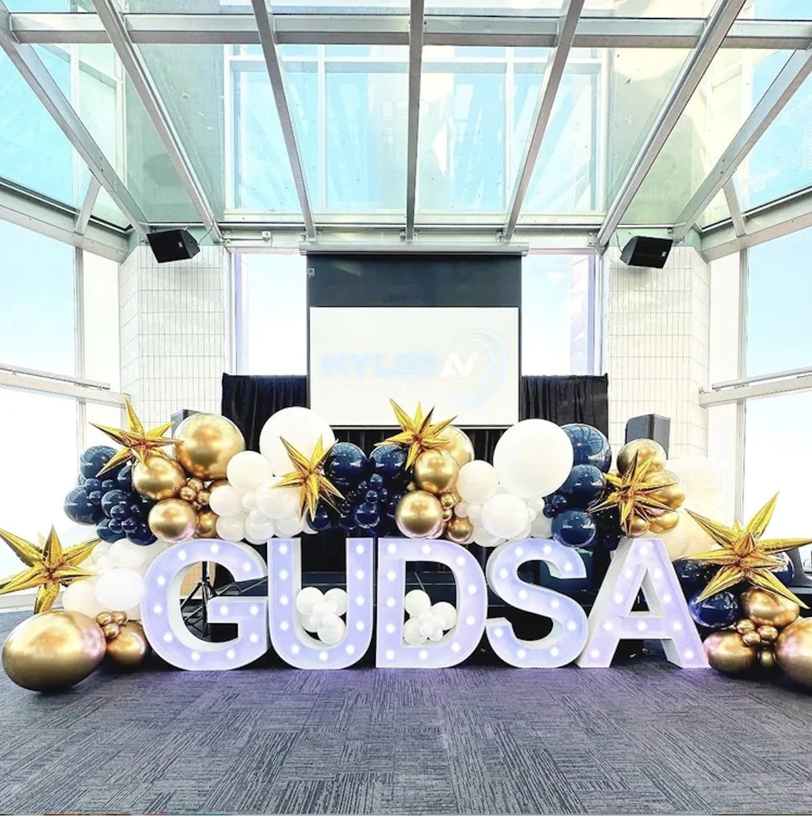 Corporate event featuring light up letters and a big balloon wall