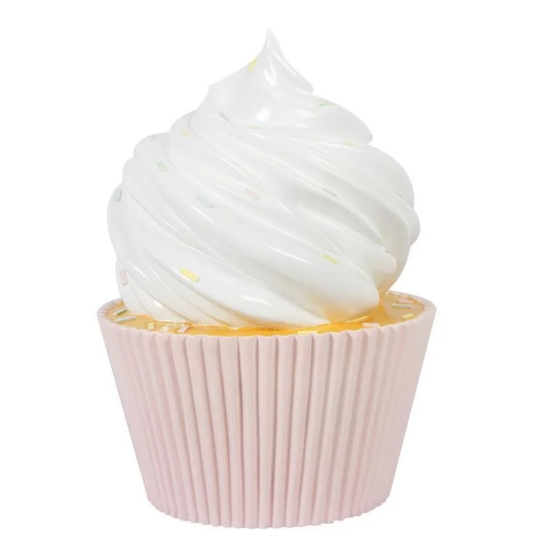 A cupcake with white swirled frosting in a pink cupcake liner.