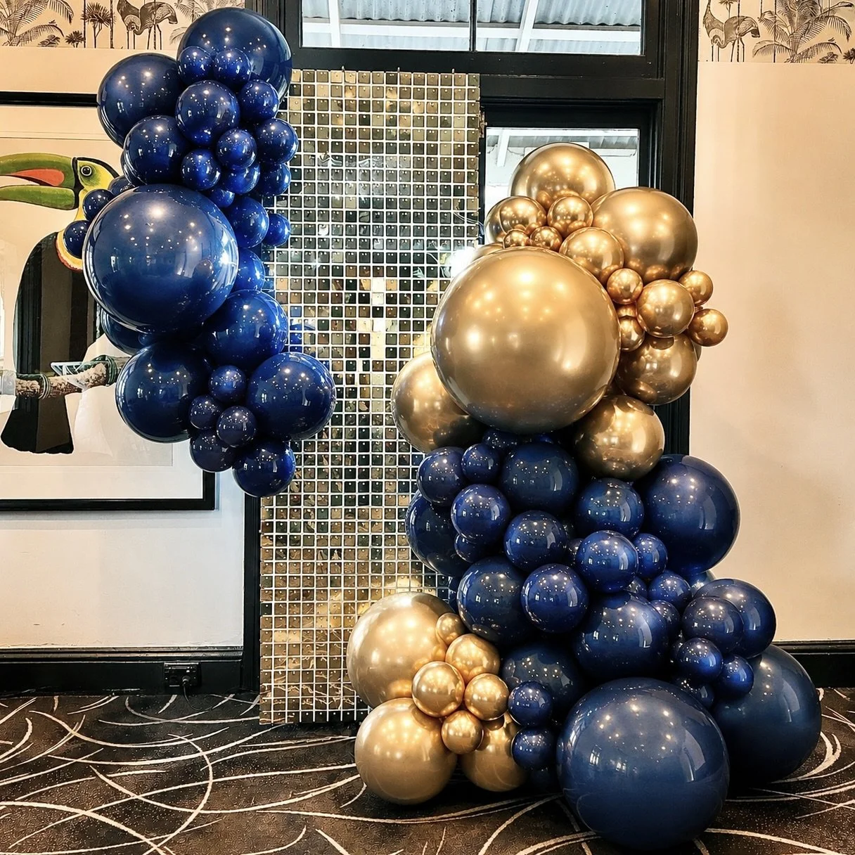 Gold shimmer wall and navy & gold balloon backdrop