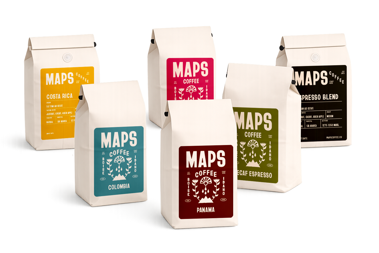 Several bags of coffee from the brand MAPS Coffee, each with a different colored label indicating different types of coffee such as Costa Rica, Colombia, Panama, and Decaf Espresso, arranged on a reflective surface.
