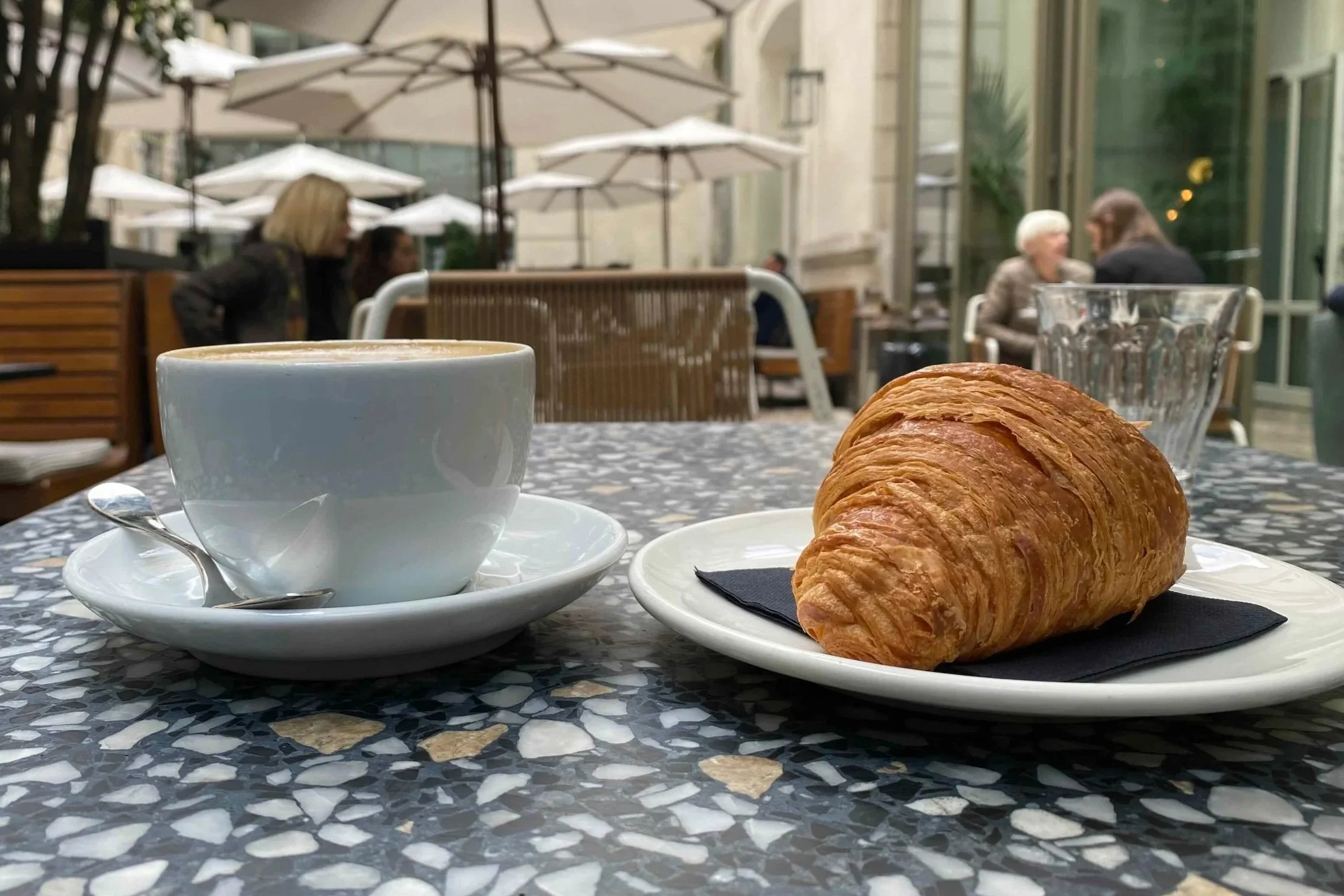 Coffee and croissant at a French café illustrating everyday lifestyle in France
