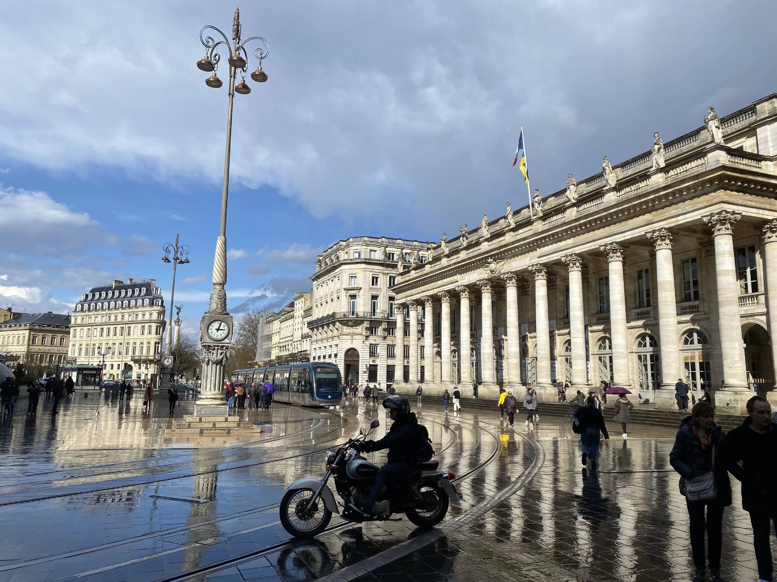 Historic architecture and tram public transportation in Bordeaux representing stability and life in France