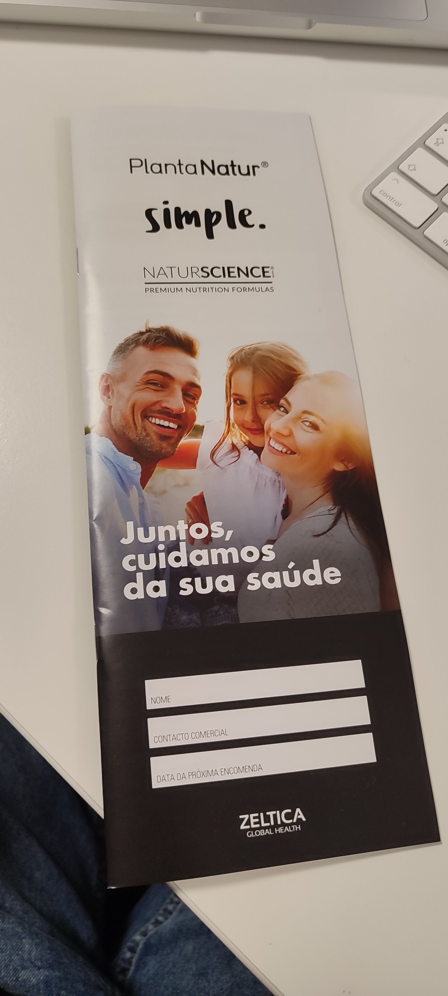 Brochure for Planta Natur, featuring a smiling family of three, with text in Portuguese that says "Juntos, cuidamos da sua saúde" and spaces to fill in name, contact, and date information, branded by Zeltica Global Health.