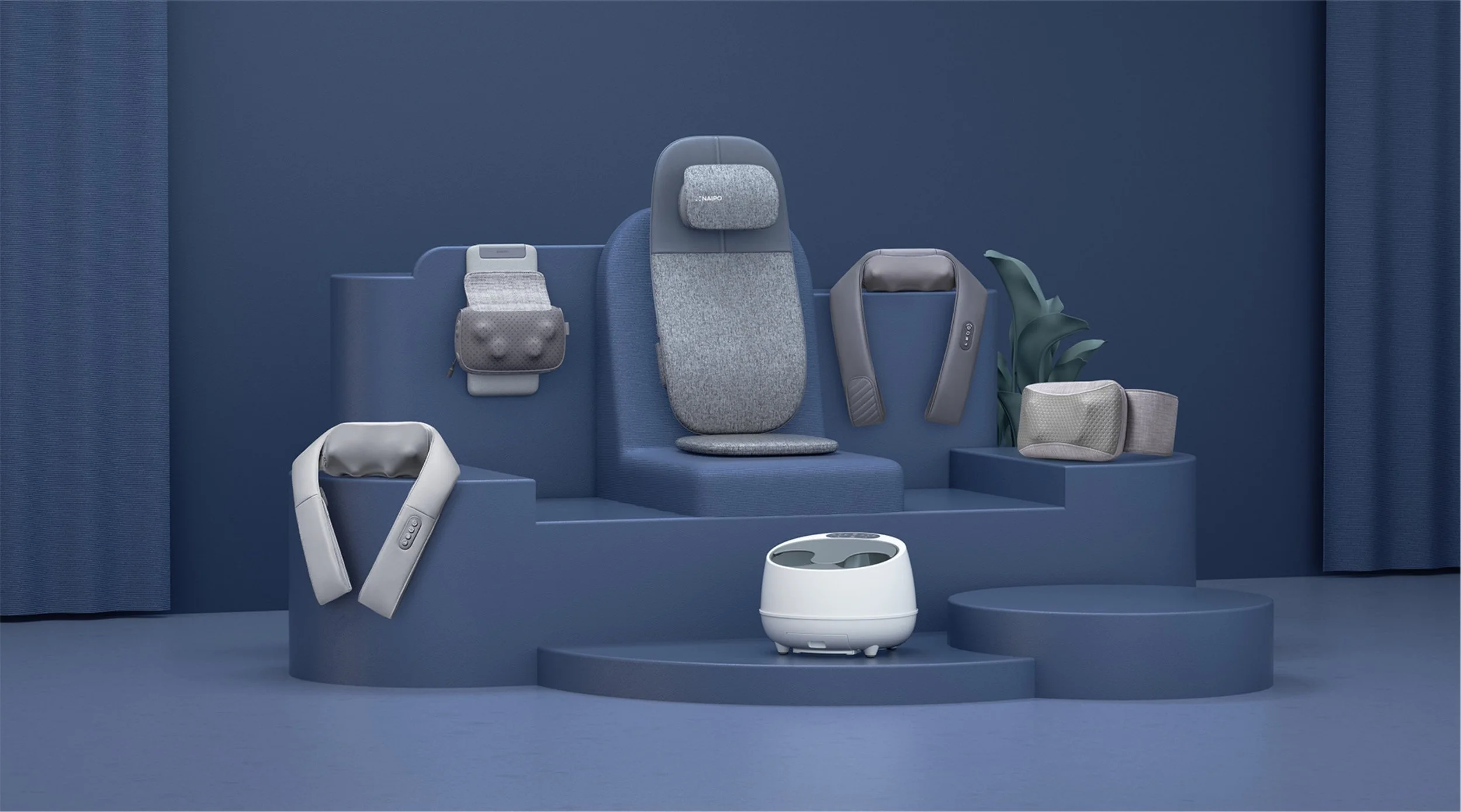 Collection of massage and wellness products displayed on blue stage with curtains in background.