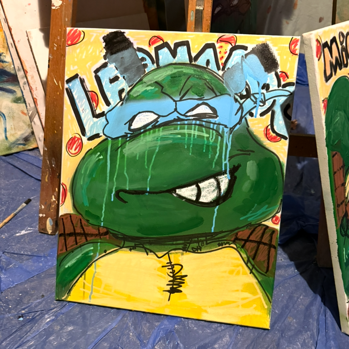 A colorful cartoon-style painting of Teenage Mutant Ninja Turtles' character, Leonardo, with a big smile, green skin, and wearing a yellow shirt. The background features various colors and designs, with the name "Leonardo" partially visible.