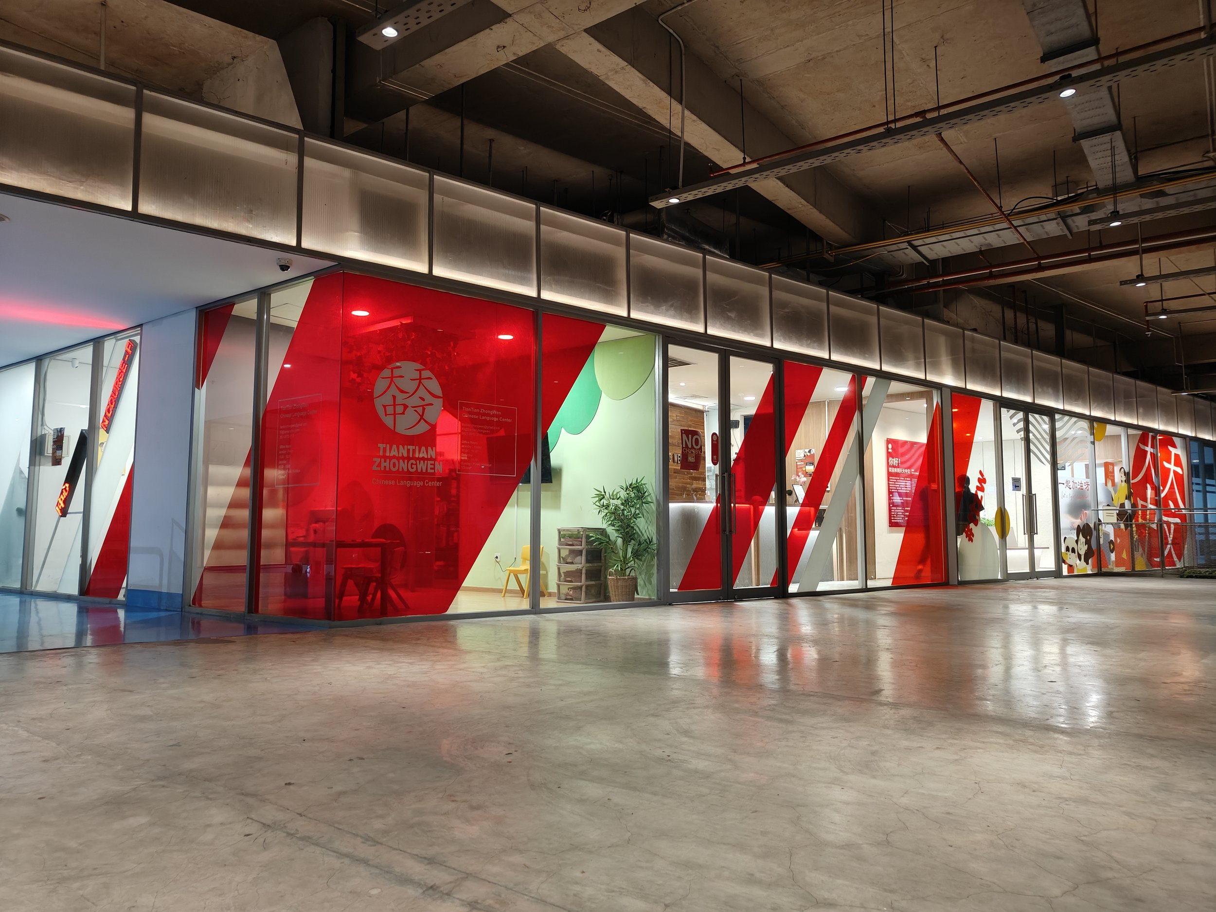 Our spazio tower branch shown here within the spazio tower mix use building. Shown here are glass walls with red branding all around.