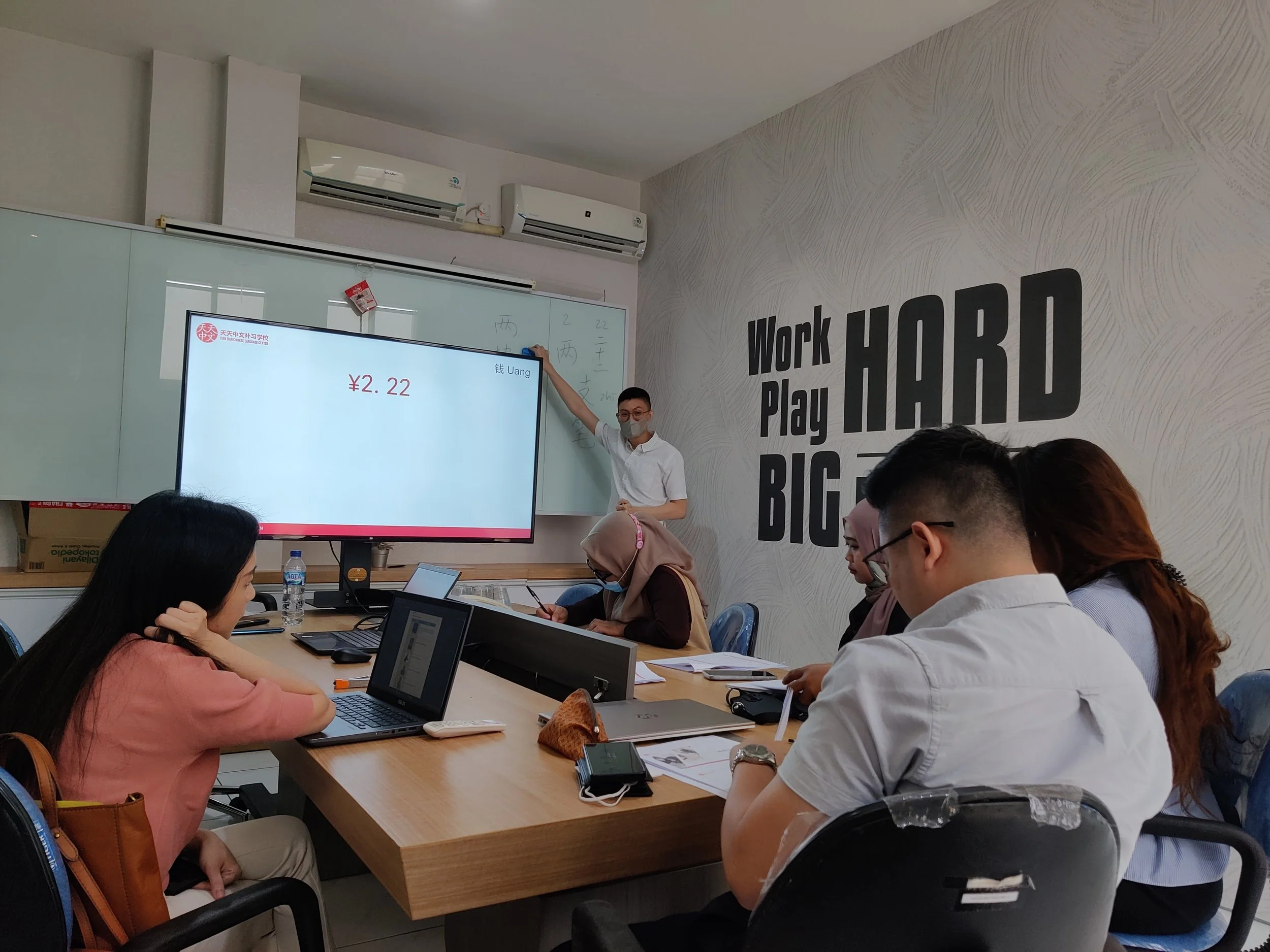 Teacher teaching a class of company workers in a company training classroom