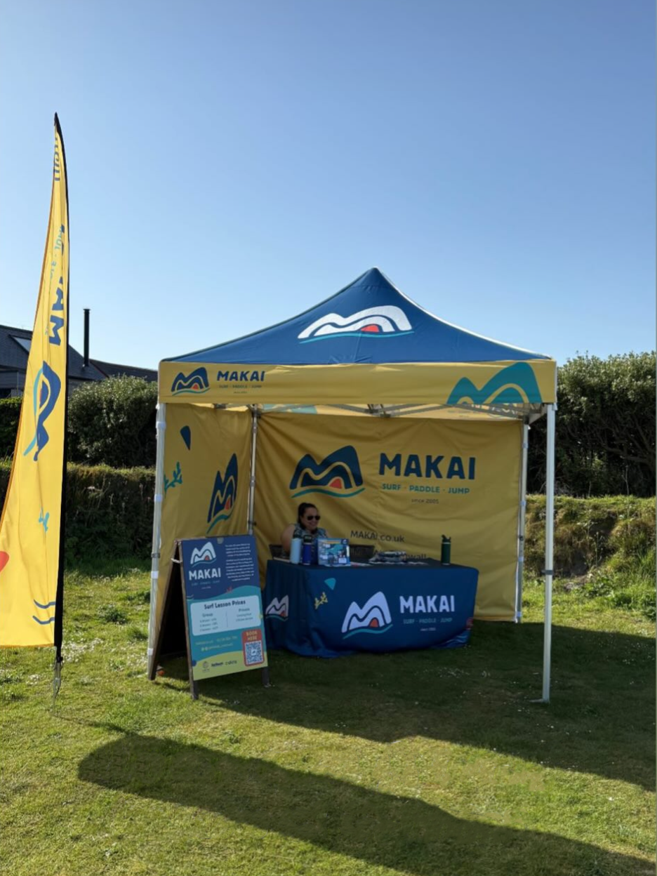 MAKAI event tent and promotional signage.