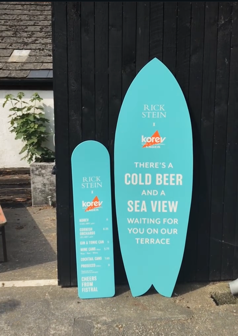 Rick Stein surfboard-shaped restaurant signage.