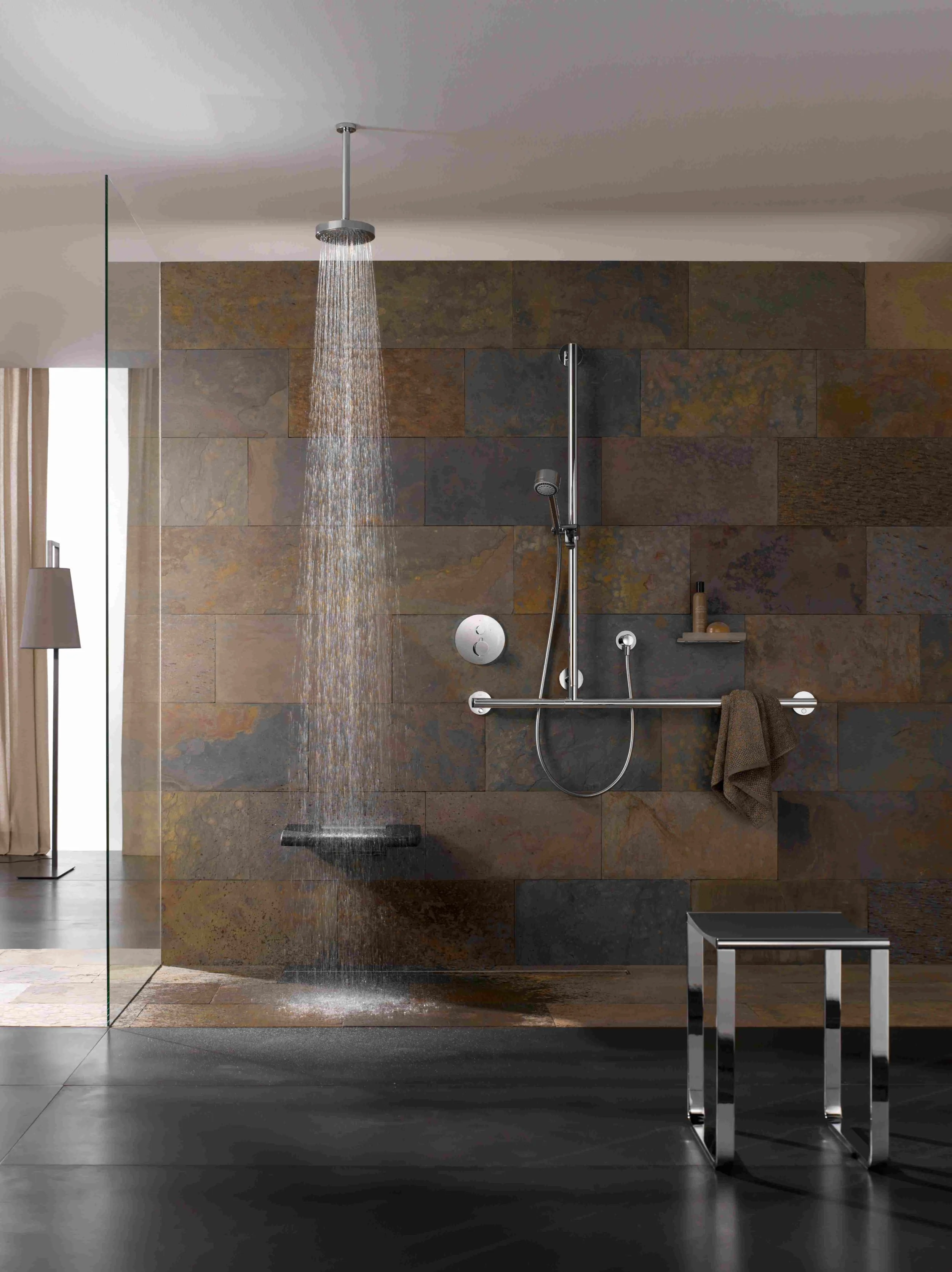 Luxury accessible wetroom with wall mounted shower seat and shower bench and rain shower.