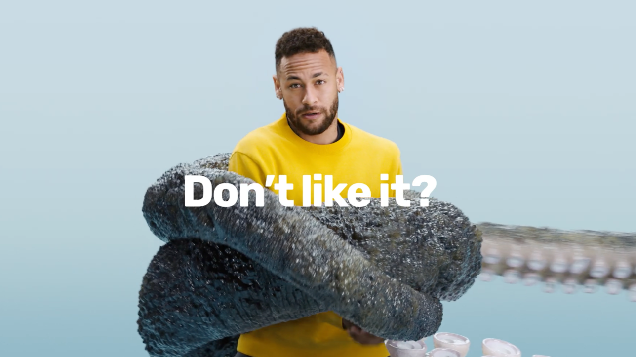 A man in a yellow shirt holding a large, dark, textured object that looks like a sea creature or seaweed, with the text 'Don't like it?' in front of him.