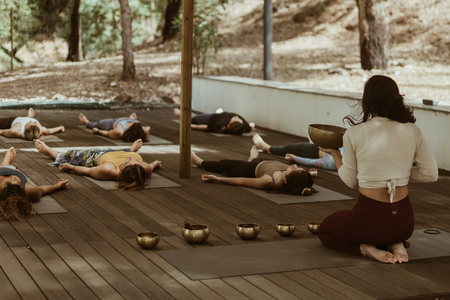 Francesca guiding a group in deep rest with singing bowls