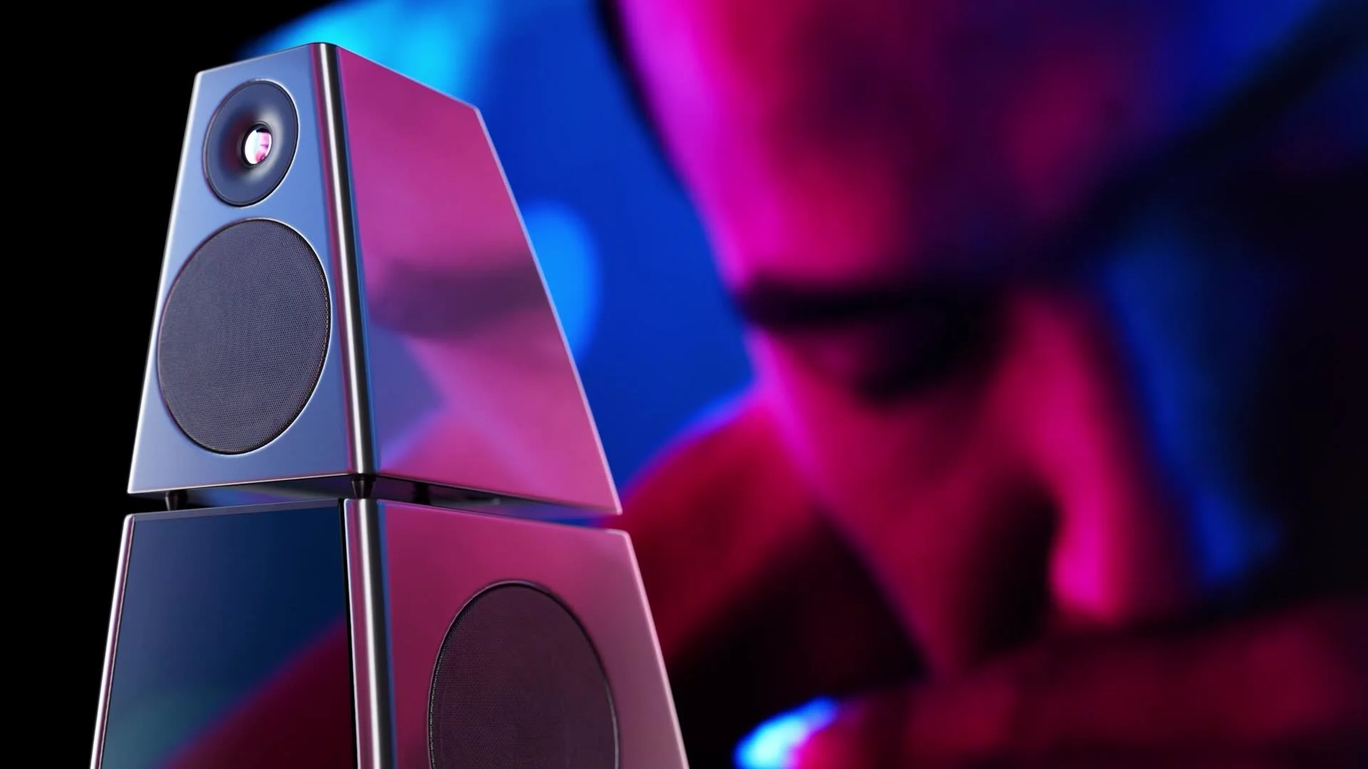 Meridian Audio loudspeaker  with a colourful, blurred background.