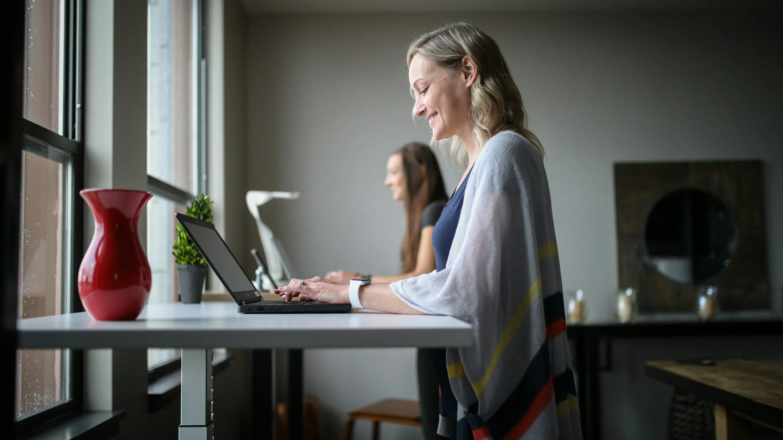 Woman typing on laptop and smiling
