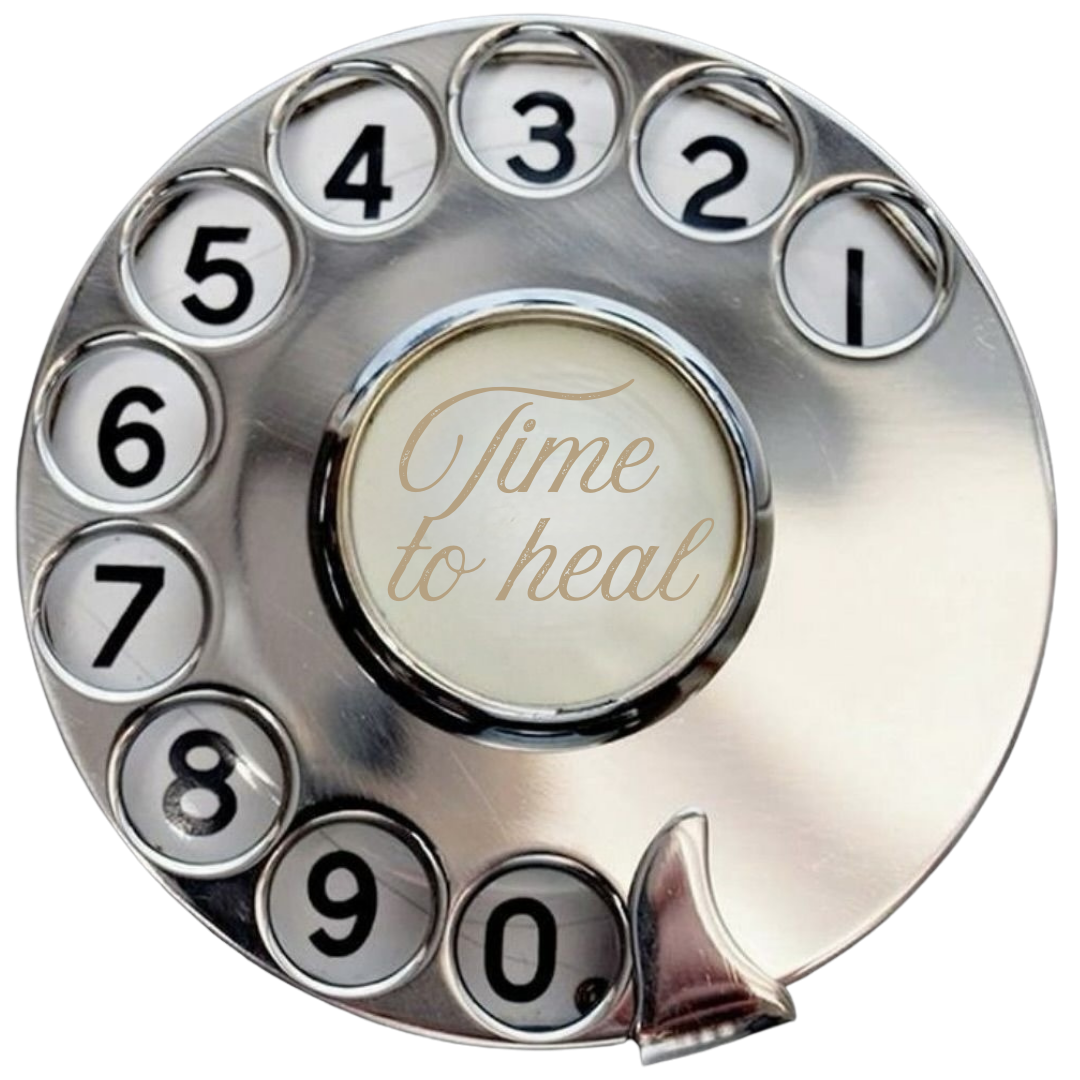 A vintage rotary phone dial with the words 'Time to heal' inscribed in the center.