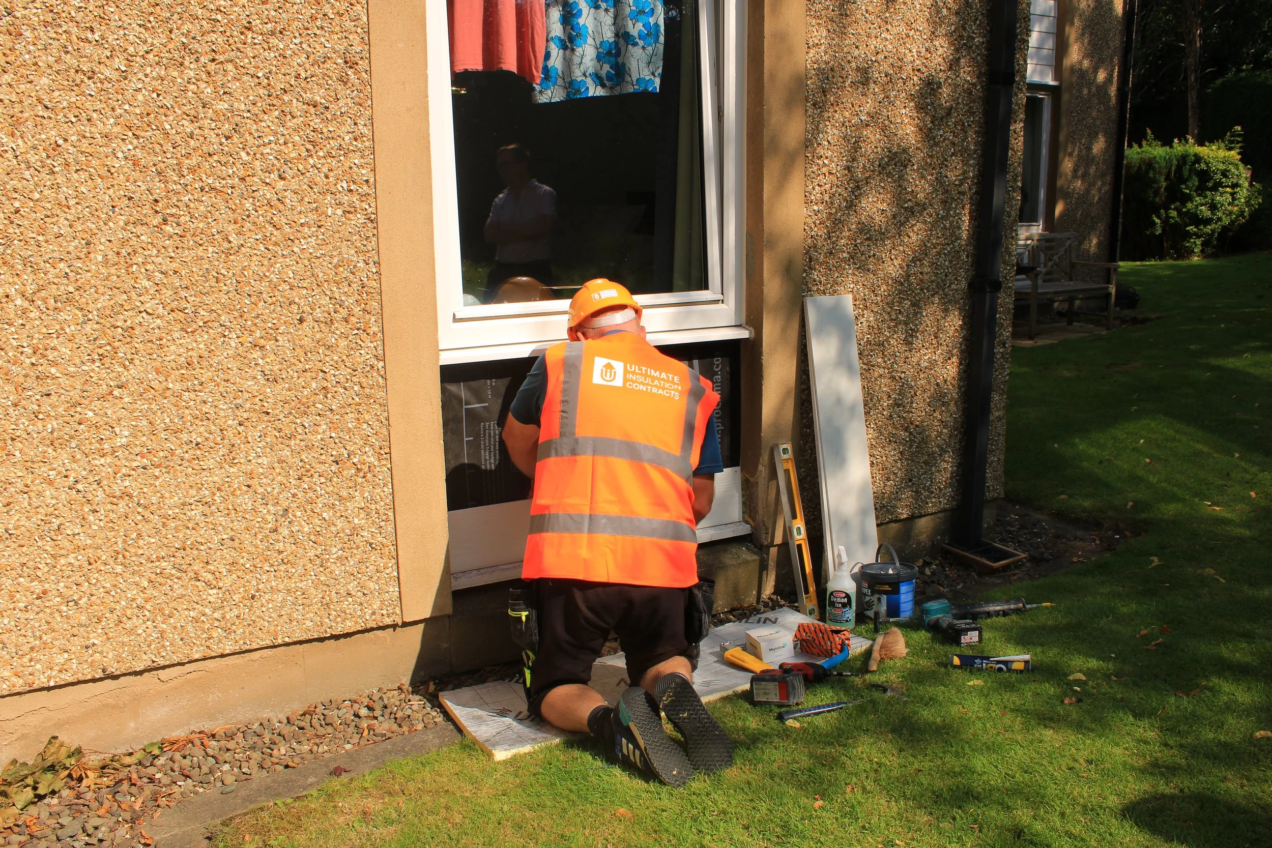 Ultimate Insulation Contracts team member installing insulation and membranes for thermal improvement in home