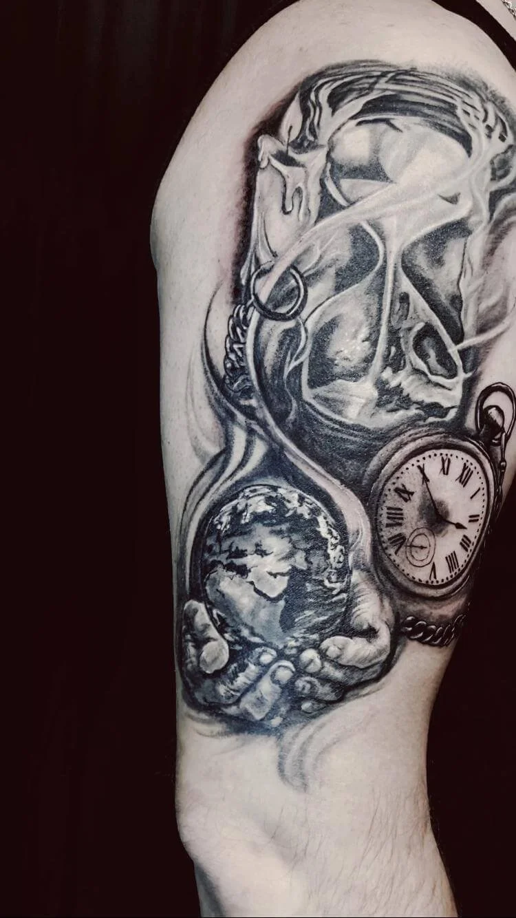 Large black and grey realism half-sleeve tattoo on the upper arm combining symbolic elements of time and mortality: a detailed hourglass at the top, hands cradling the Earth globe in the centre, and a Roman numeral pocket watch on a chain to the righ