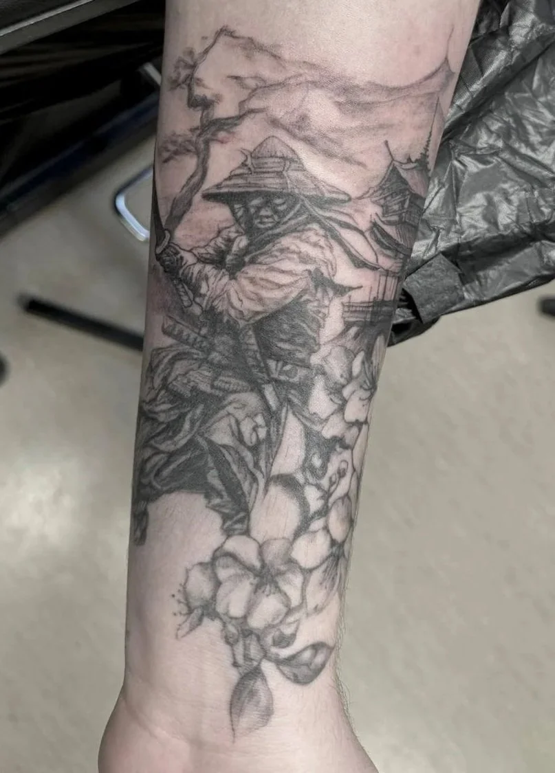 Fine-line illustrative forearm tattoo fresh — Japanese samurai with pagoda, mountain range and cherry blossom in black and grey by Siren Tattoo, Lucerne
