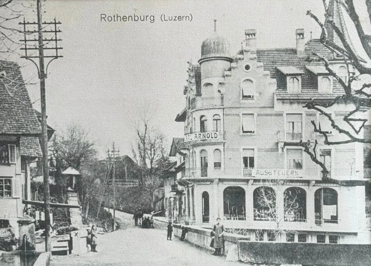 Framed vintage black and white postcard captioned "Rothenburg (Luzern)" showing a street view of the historic Arnold building — the current location of Siren Tattoo Studio — with period pedestrians and traditional architecture. Lucerne, Switzerland.