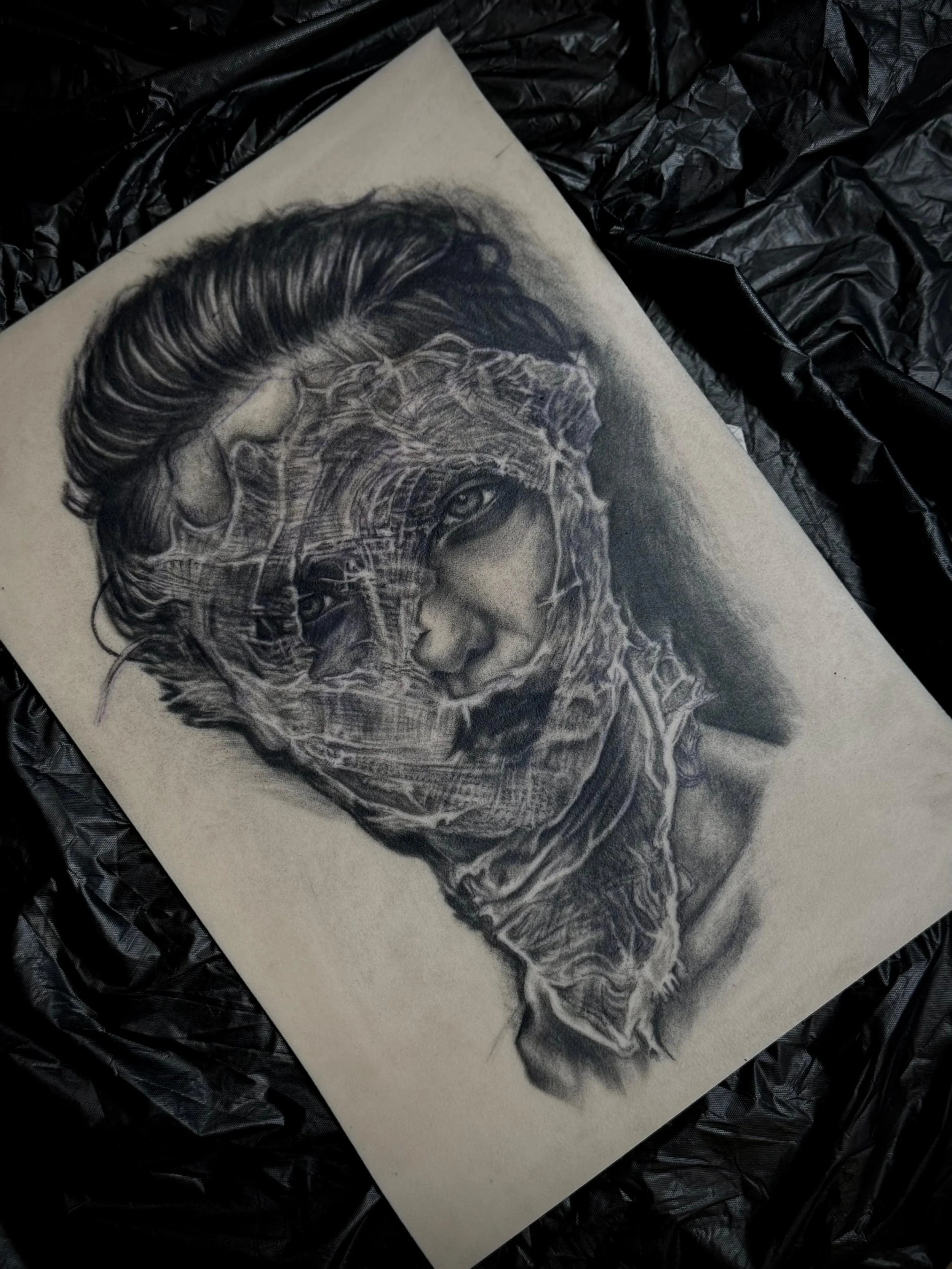 Original pencil drawing on paper — dark portrait of a face wrapped in thorned wire mesh, private art by Siren Tattoo Lucerne