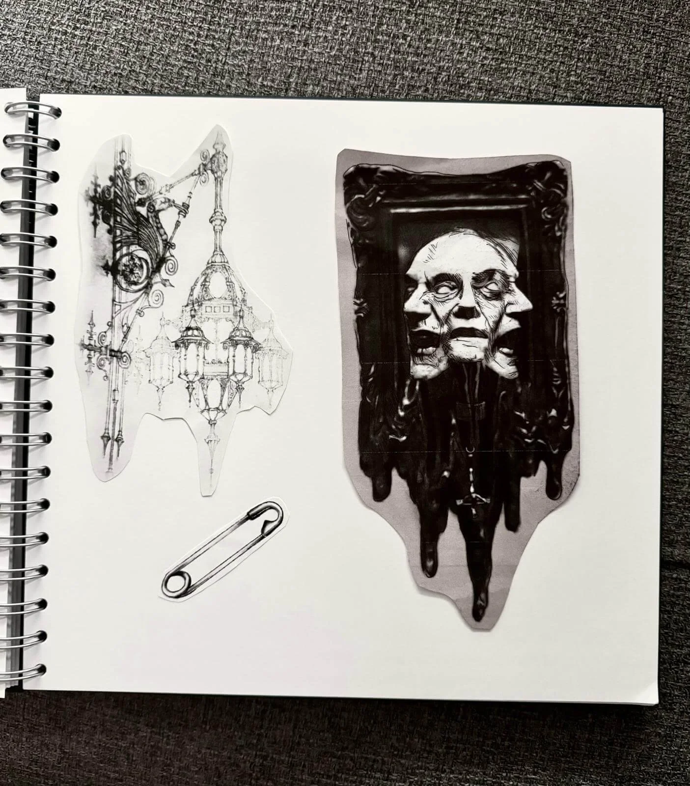 Sketchbook page with dark illustrative flash sticker designs — gothic chandelier with bat wings, plain safety pin, and melting three-faced portrait in ornate frame by Siren Tattoo Lucerne