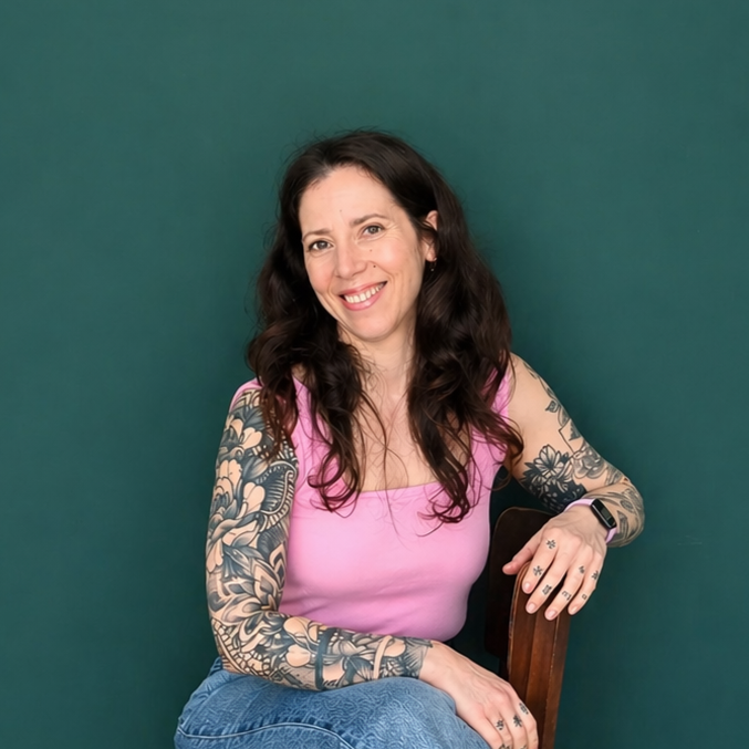 Headshot of smiling male tutor with medium-length black hair wearing a lanyard.