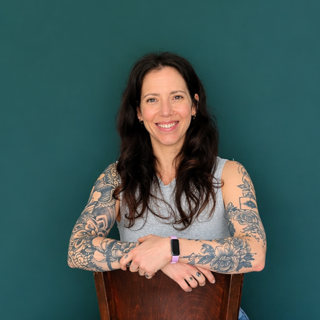 Headshot of smiling female tutor with short blonde hair wearing a lanyard.