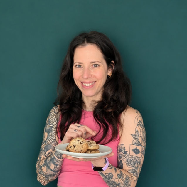 Headshot of smiling female tutor with long braids wearing a lanyard.
