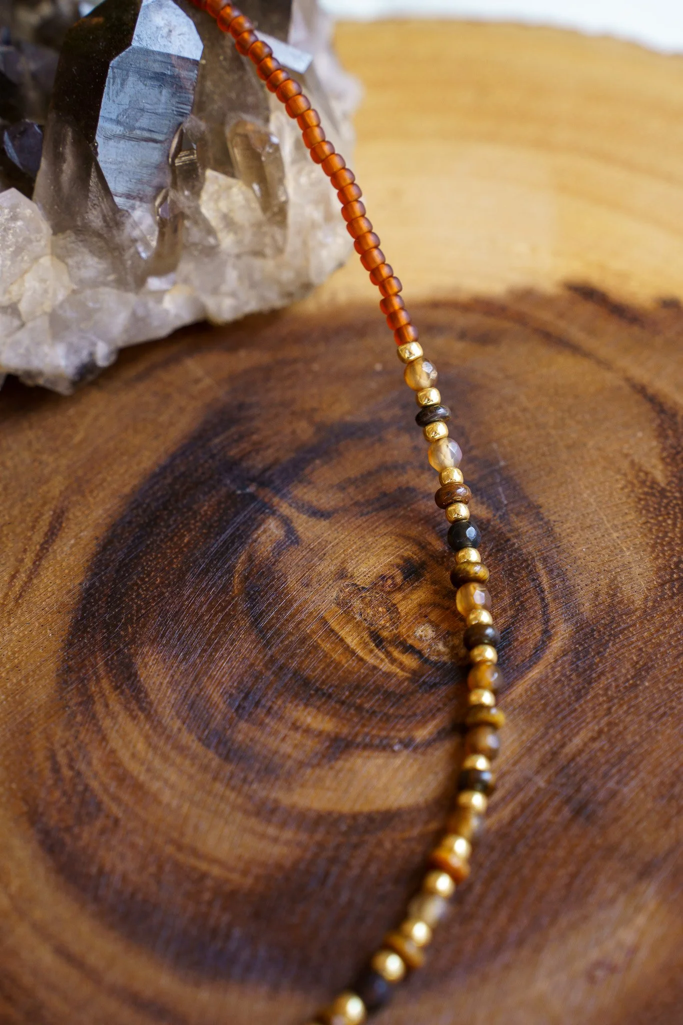 Handmade tiger’s eye stone necklace with rust brown and gold seed beads and 18k gold PVD findings. Necklace measures approximately 17" with a 2" extender.