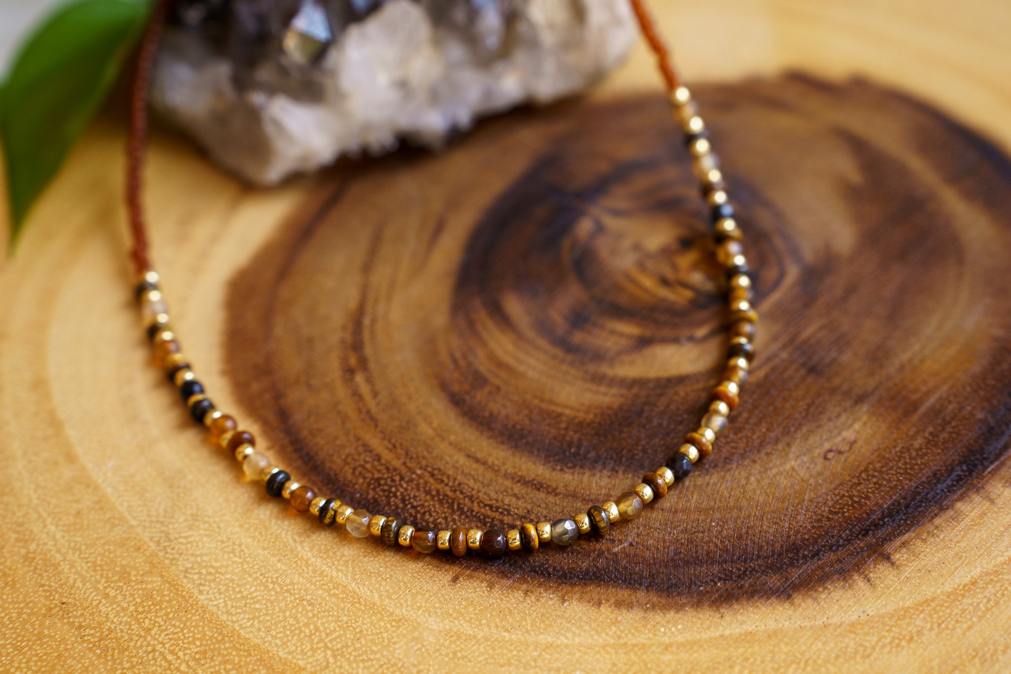 Handmade tiger’s eye stone necklace with rust brown and gold seed beads and 18k gold PVD findings. Necklace measures approximately 17" with a 2" extender.