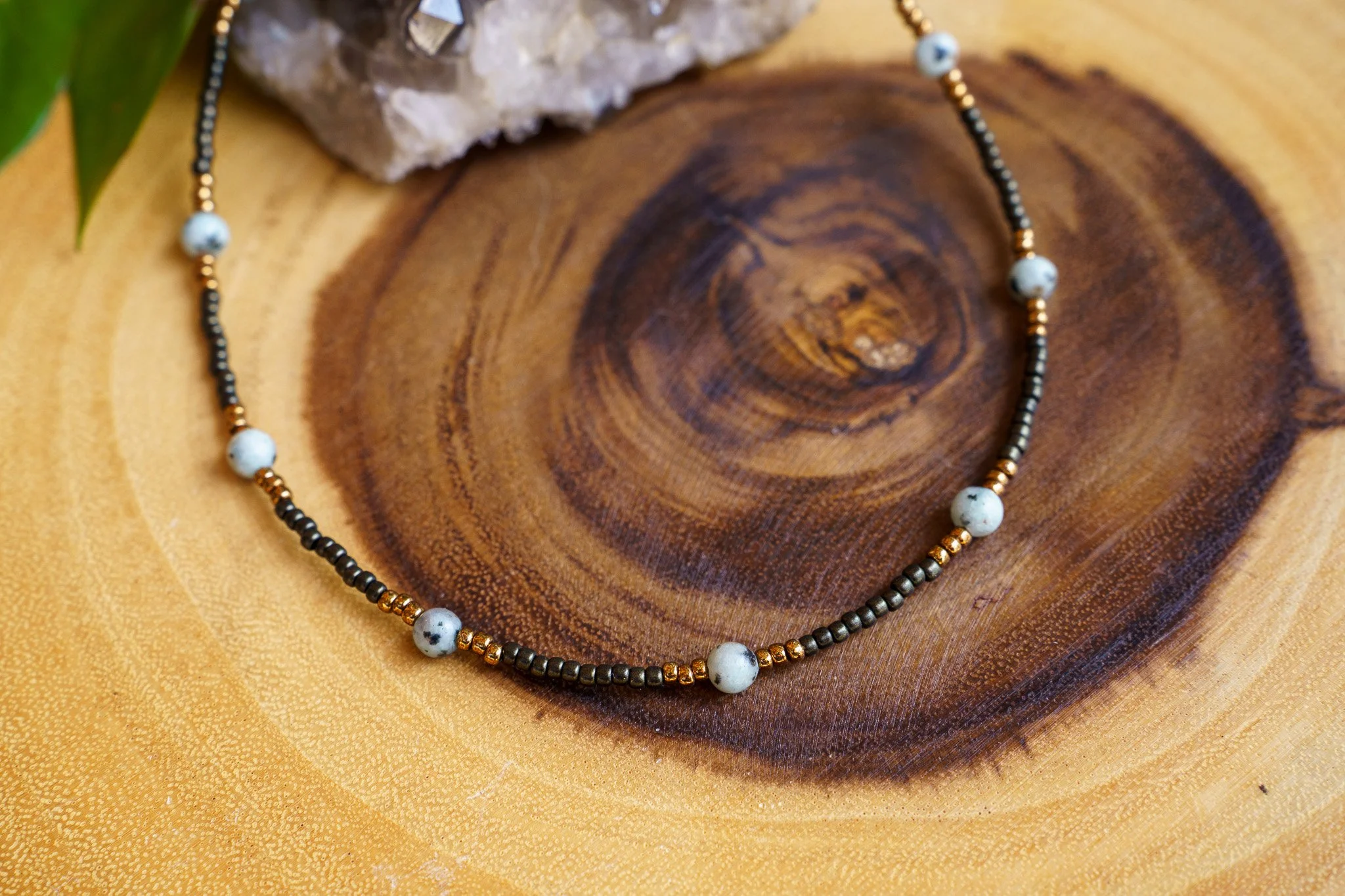 Handmade kiwi jasper necklace with black and bronze seed beads and 18k gold PVD findings. Necklace measures approximately 16" with a 2" extender.