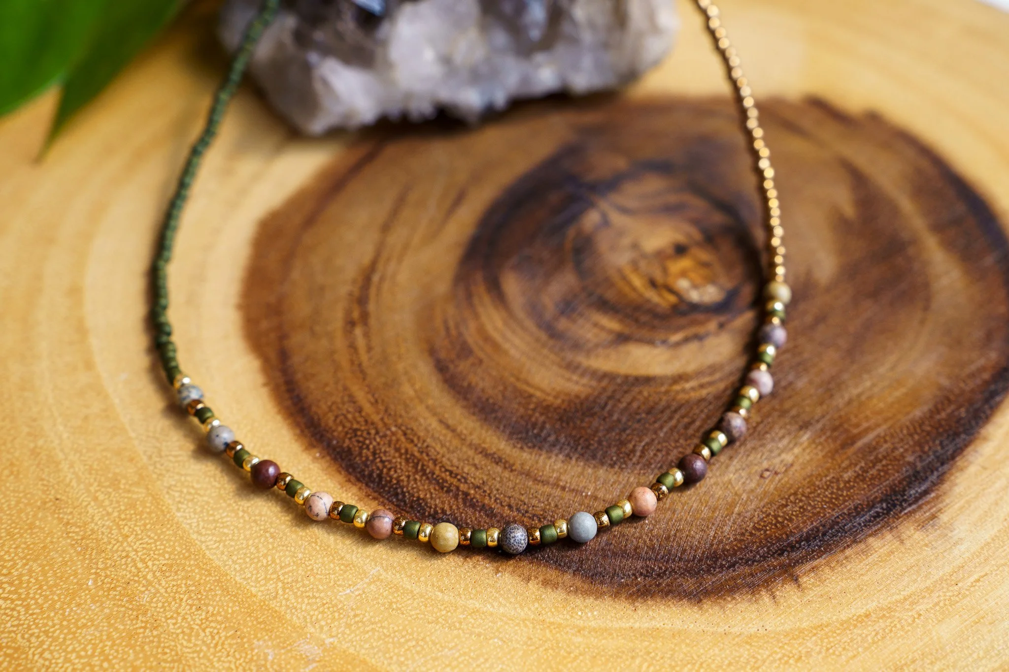 Handmade pink zebra jasper necklace with green and gold seed beads and 18k gold PVD findings. Necklace measures approximately 16" with a 2" extender.