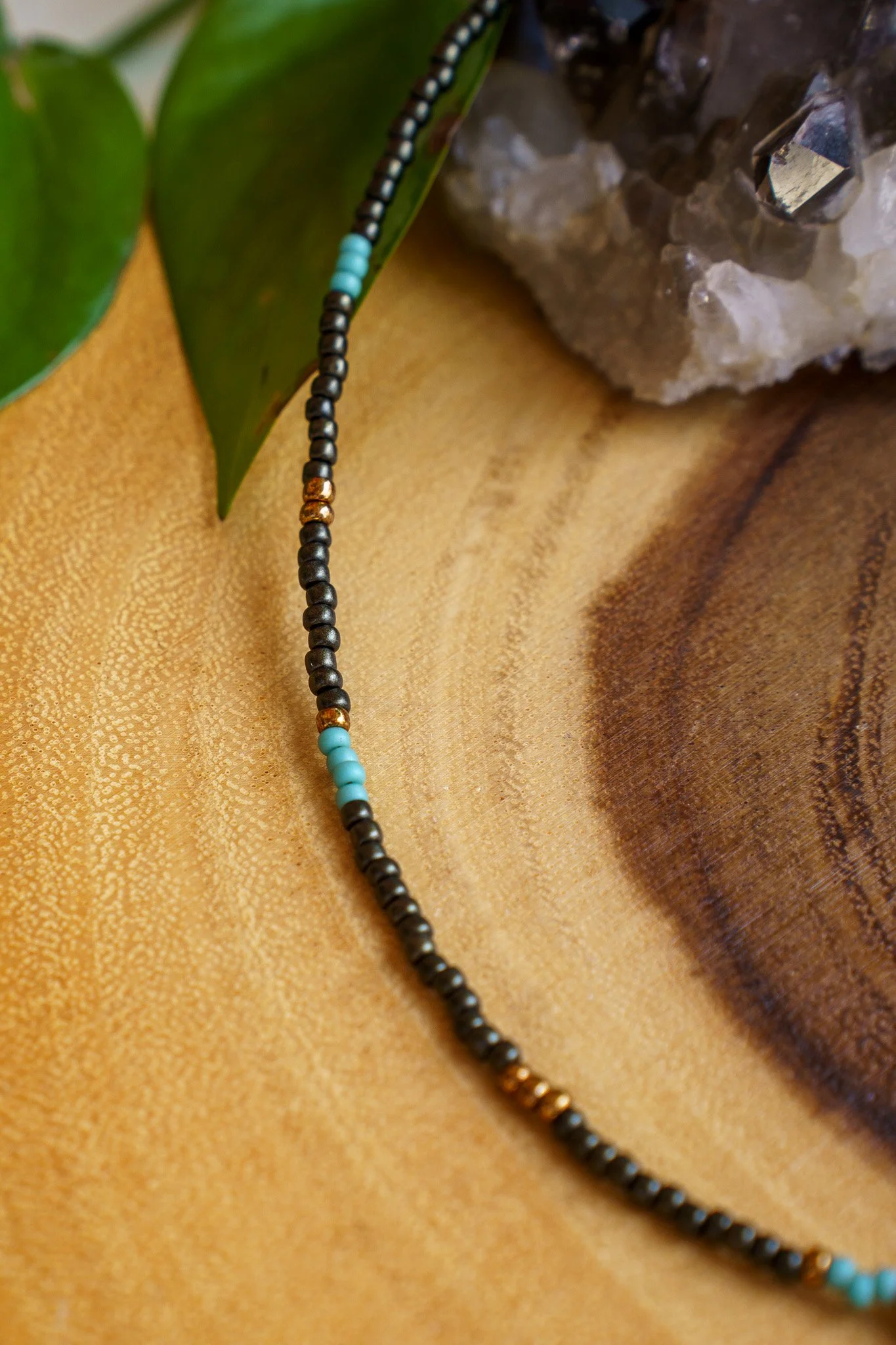 Handmade necklace with three kiwi jasper stones and black and bronze seed beads with 18k gold PVD findings. Necklace measures approximately 16" with a 2" extender.