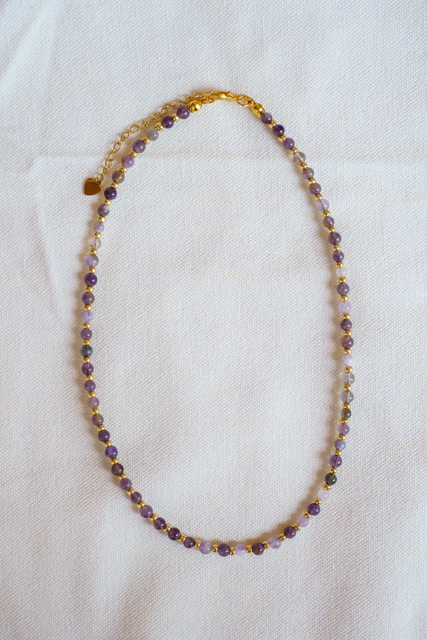 Handmade amethyst bead necklace with gold seed beads and 18k gold PVD findings. Necklace measures approximately 15.5" with a 2" extender.