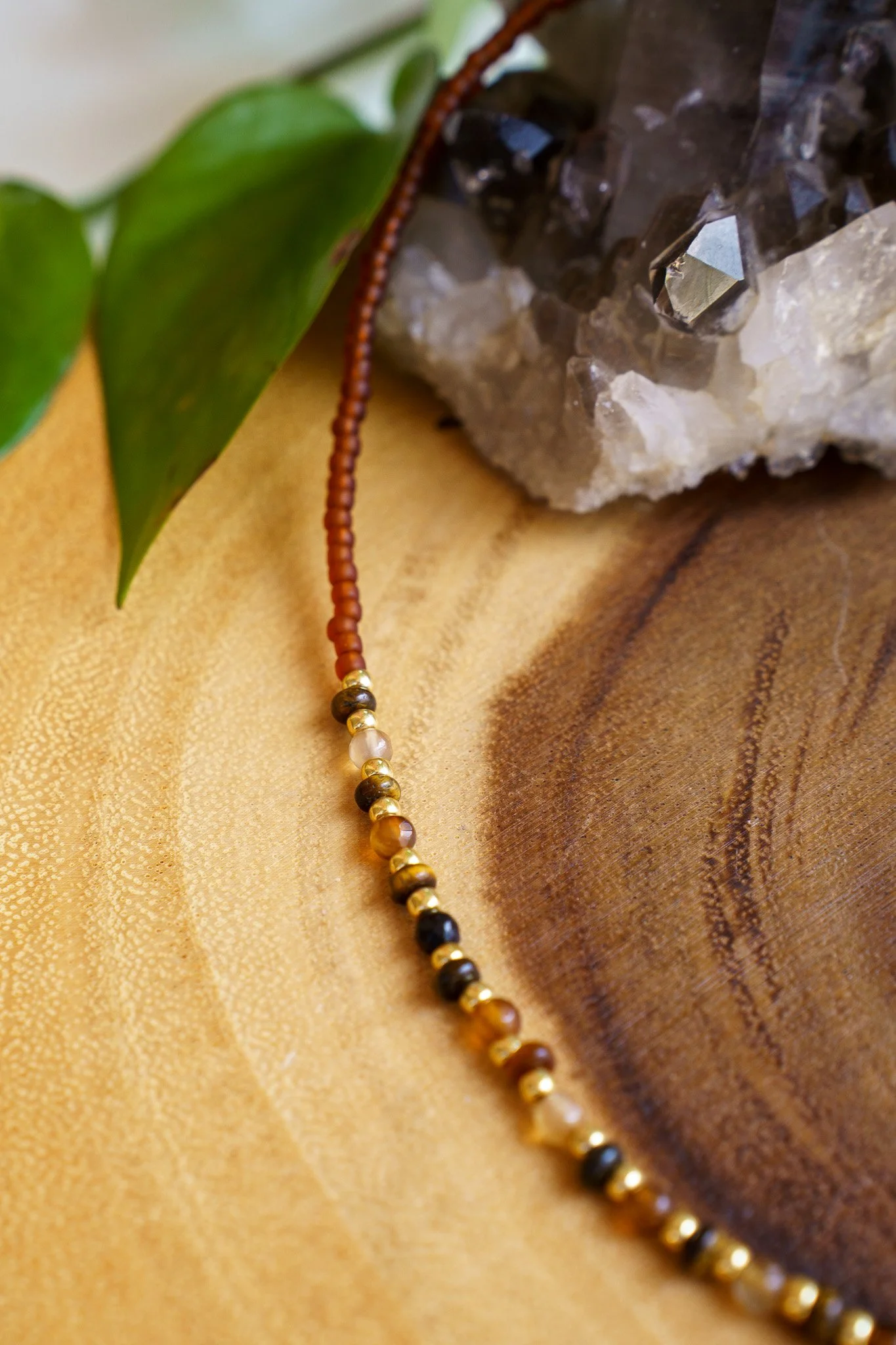 Handmade tiger’s eye stone necklace with rust brown and gold seed beads and 18k gold PVD findings. Necklace measures approximately 17" with a 2" extender.
