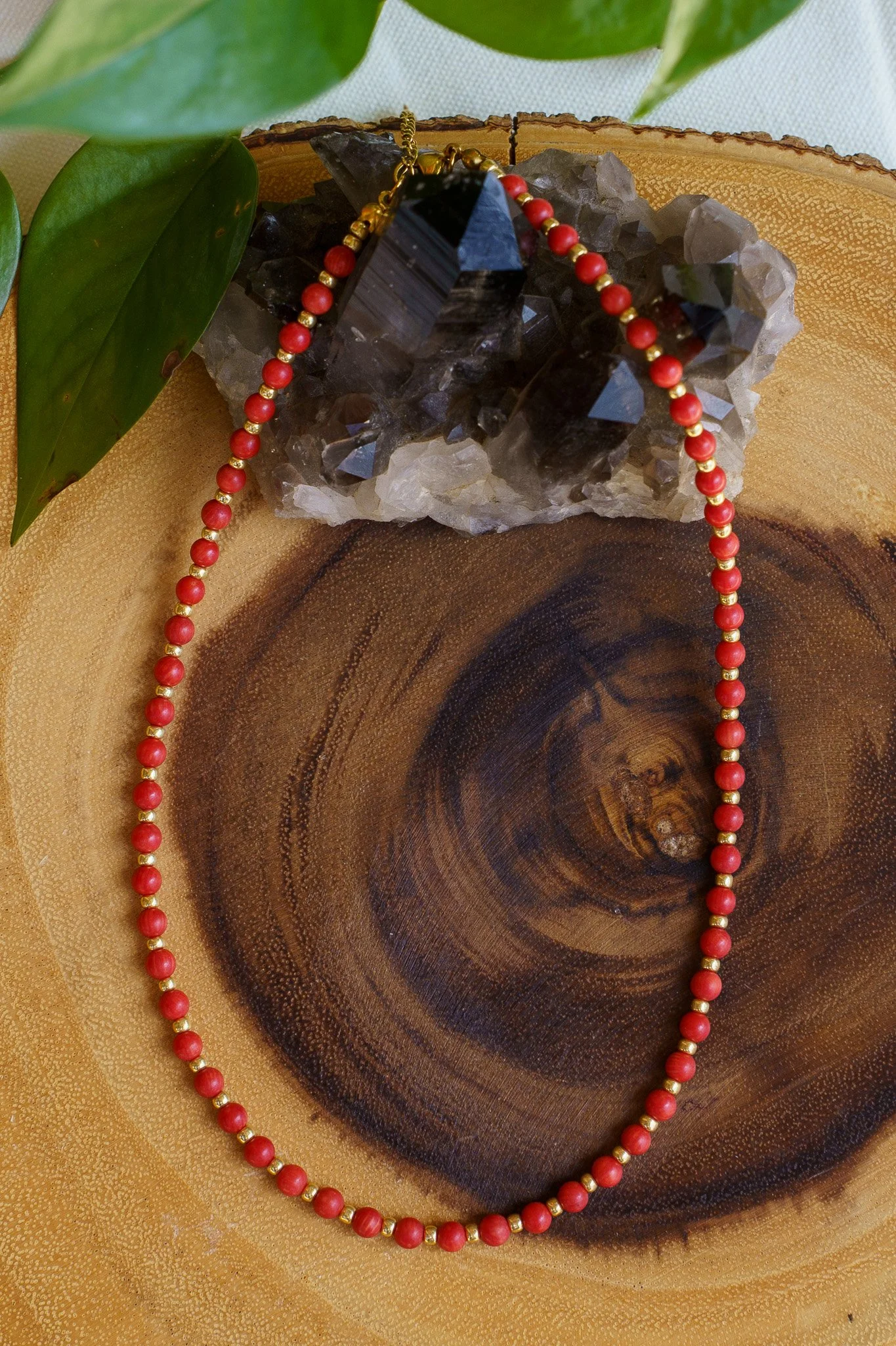 Handmade coral bead necklace with gold seed beads and 18k gold PVD findings. Necklace measures approximately 17" with a 2" extender.