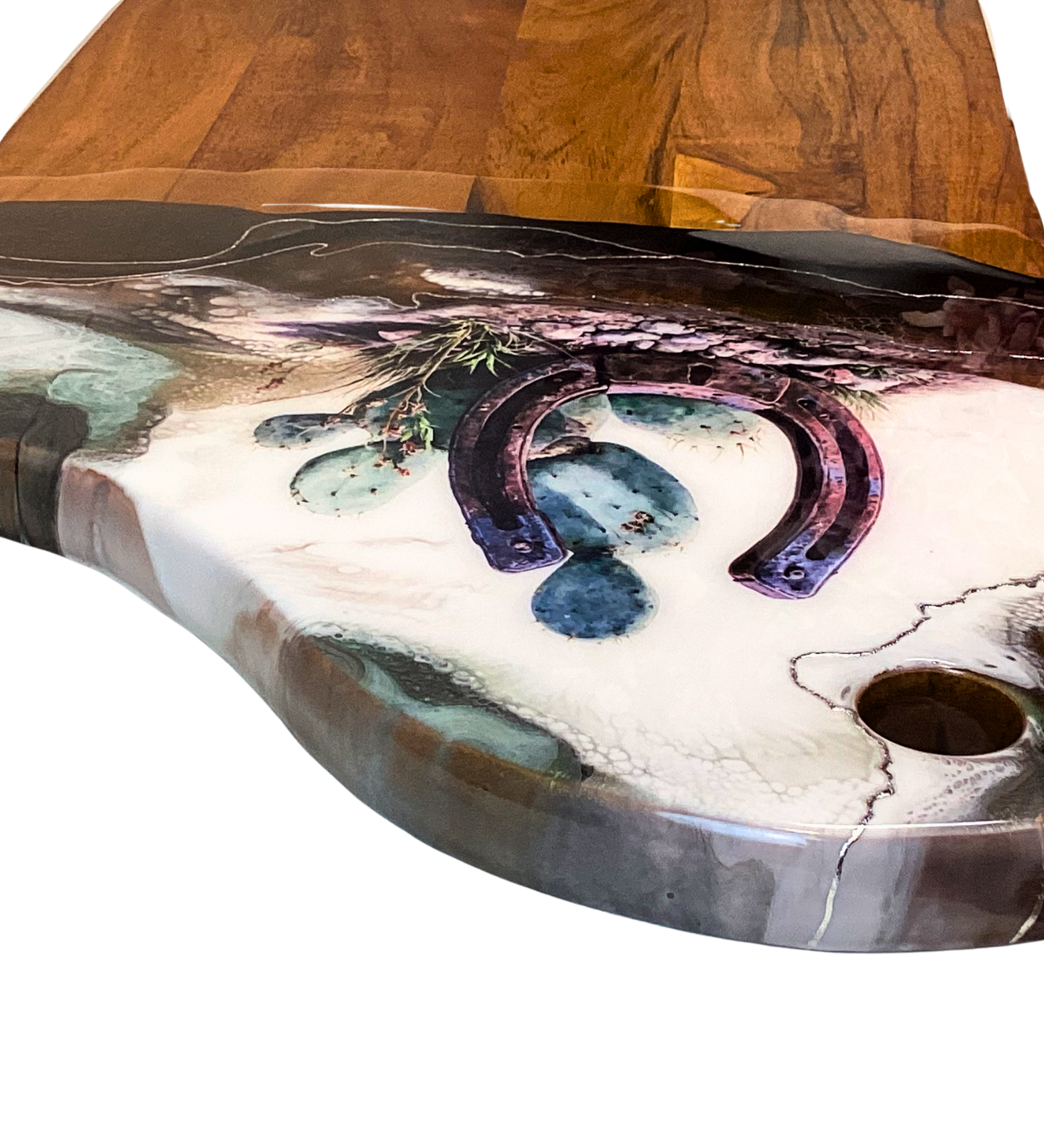 Handcrafted acacia charcuterie board featuring a rustic horseshoe standing upright with cactus behind it, accented with pure silver, Western décor style.