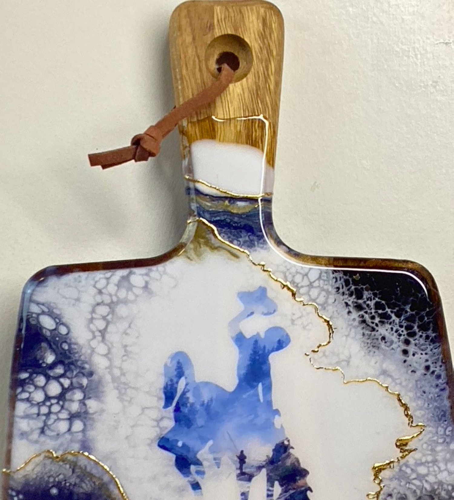 Handmade Wyoming charcuterie board with fly fisherman scene, resin art, and 24K gold accents on acacia wood