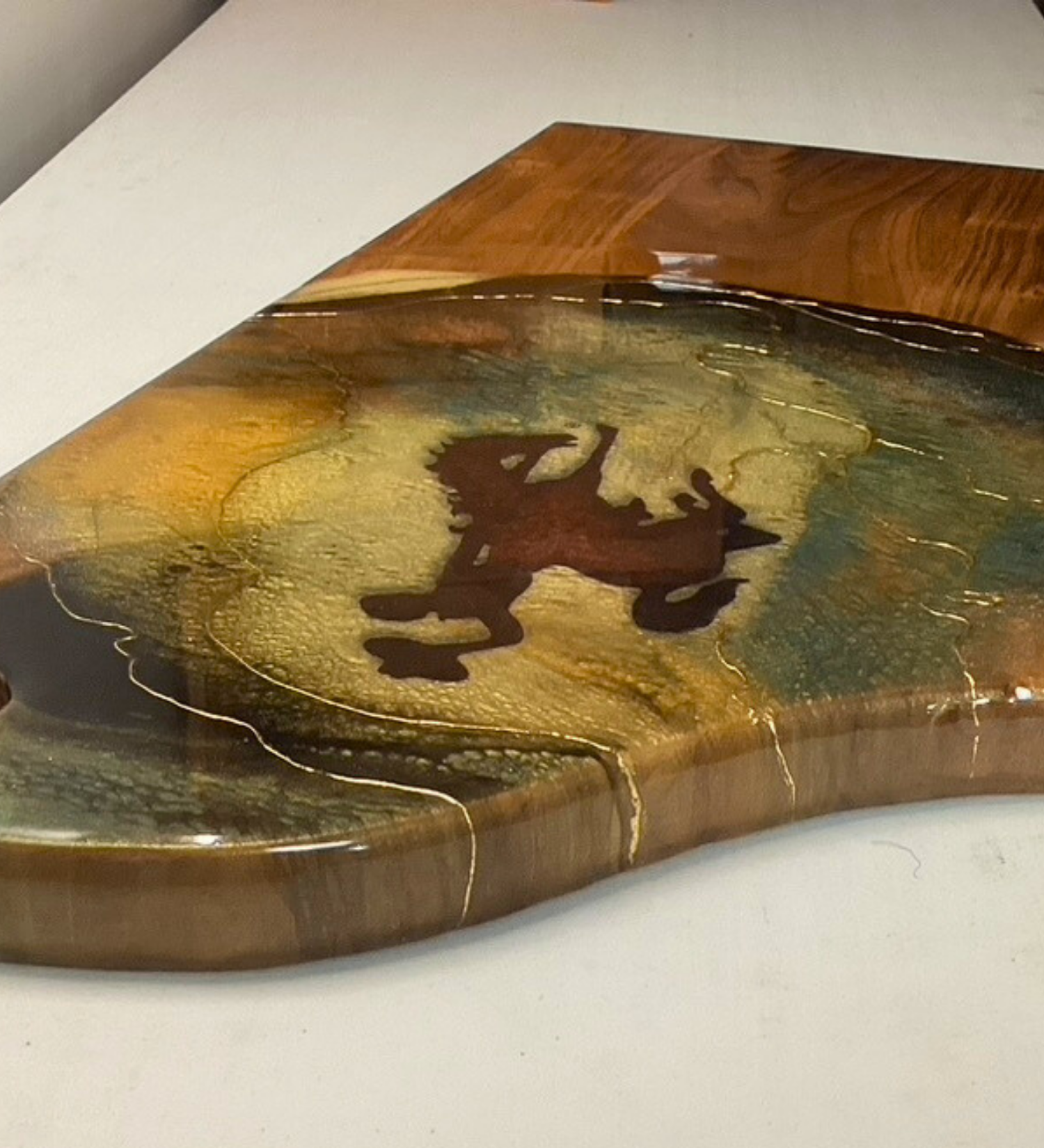 Handcrafted Wyoming cowboy charcuterie board featuring flowing resin art on acacia wood. A one-of-a-kind Western serving board and artisan kitchen gift.
