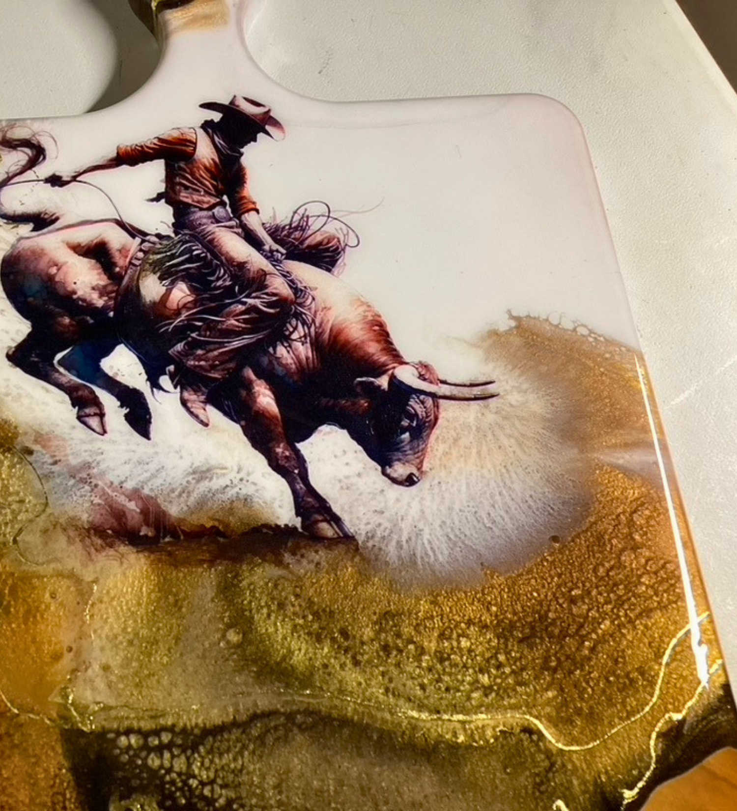 Handmade western charcuterie board featuring bull rider artwork with gold resin accents on natural wood