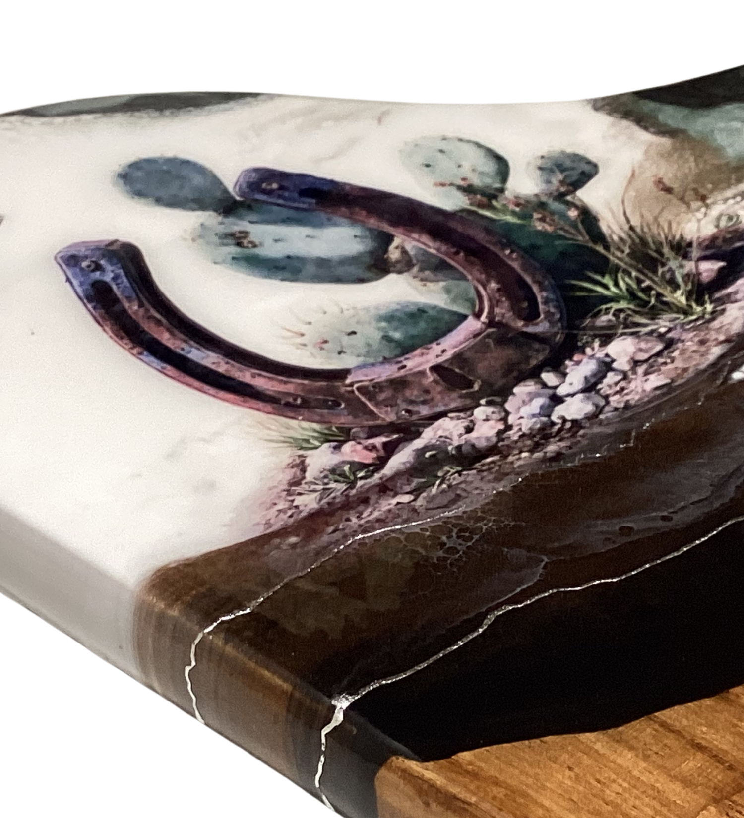 Handcrafted acacia charcuterie board featuring a rustic horseshoe standing upright with cactus behind it, accented with pure silver, Western décor style.