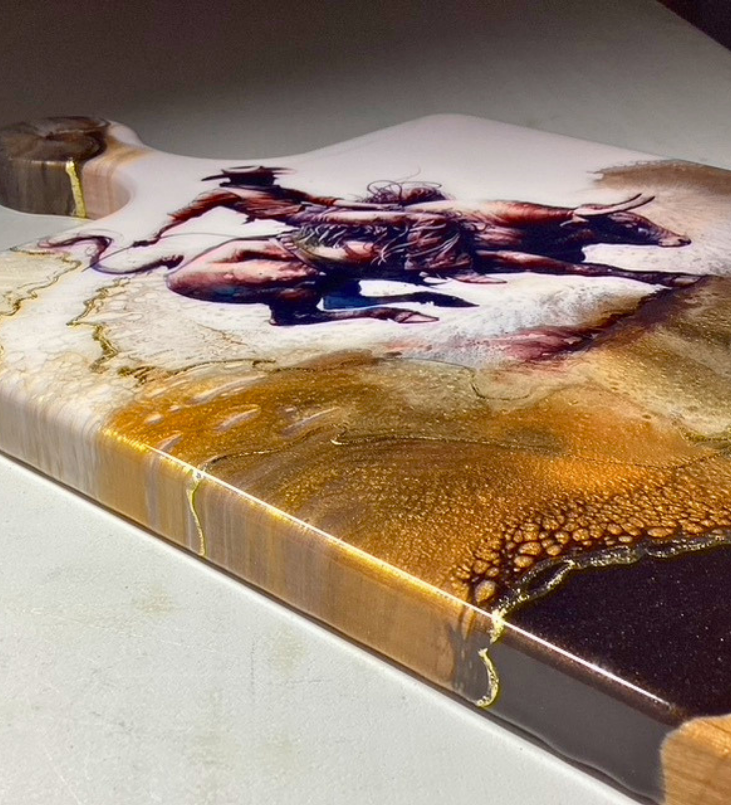 Handmade western charcuterie board featuring bull rider artwork with gold resin accents on natural wood