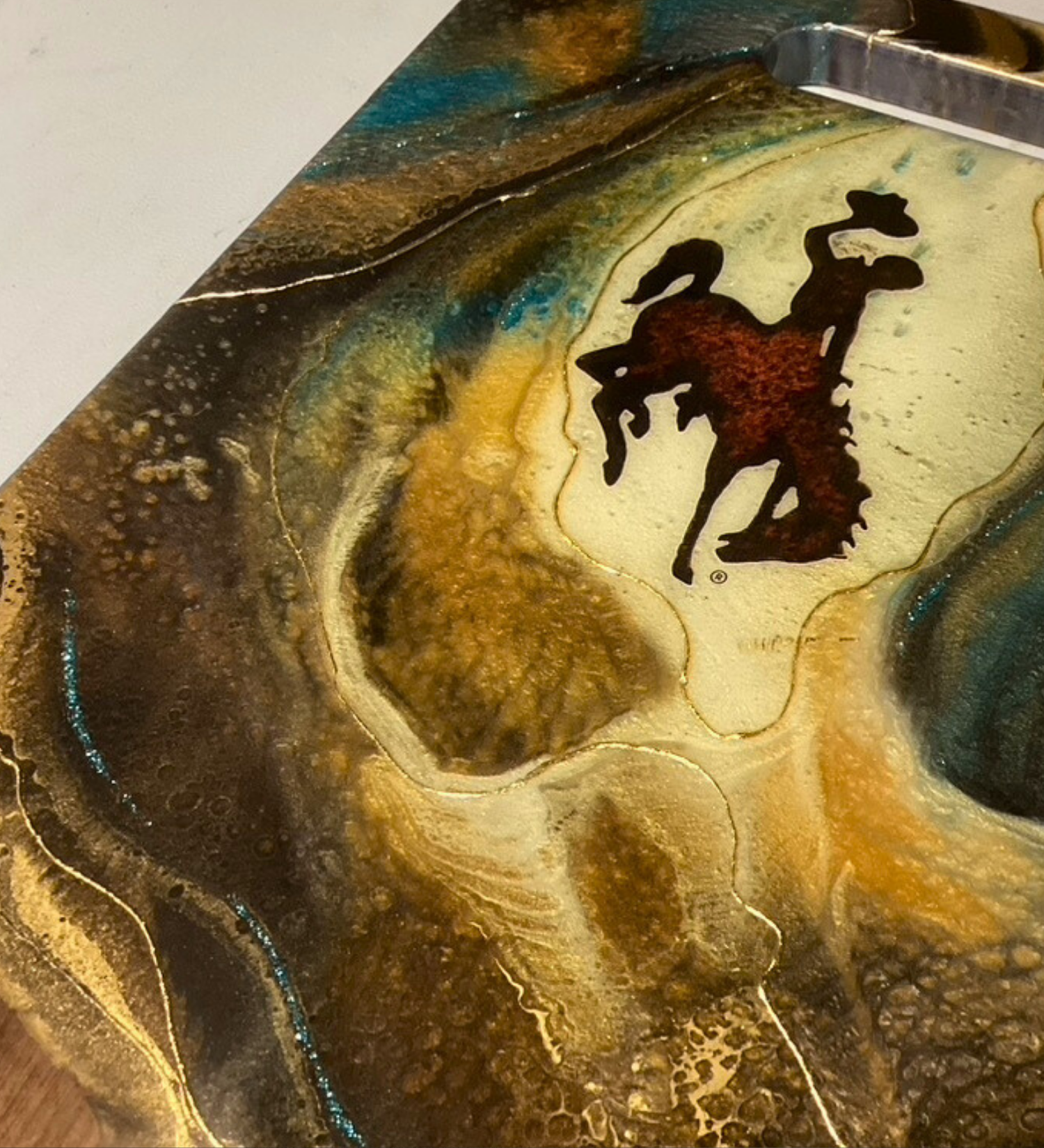 Handcrafted Wyoming cowboy charcuterie board featuring flowing resin art on walnut hardwood.