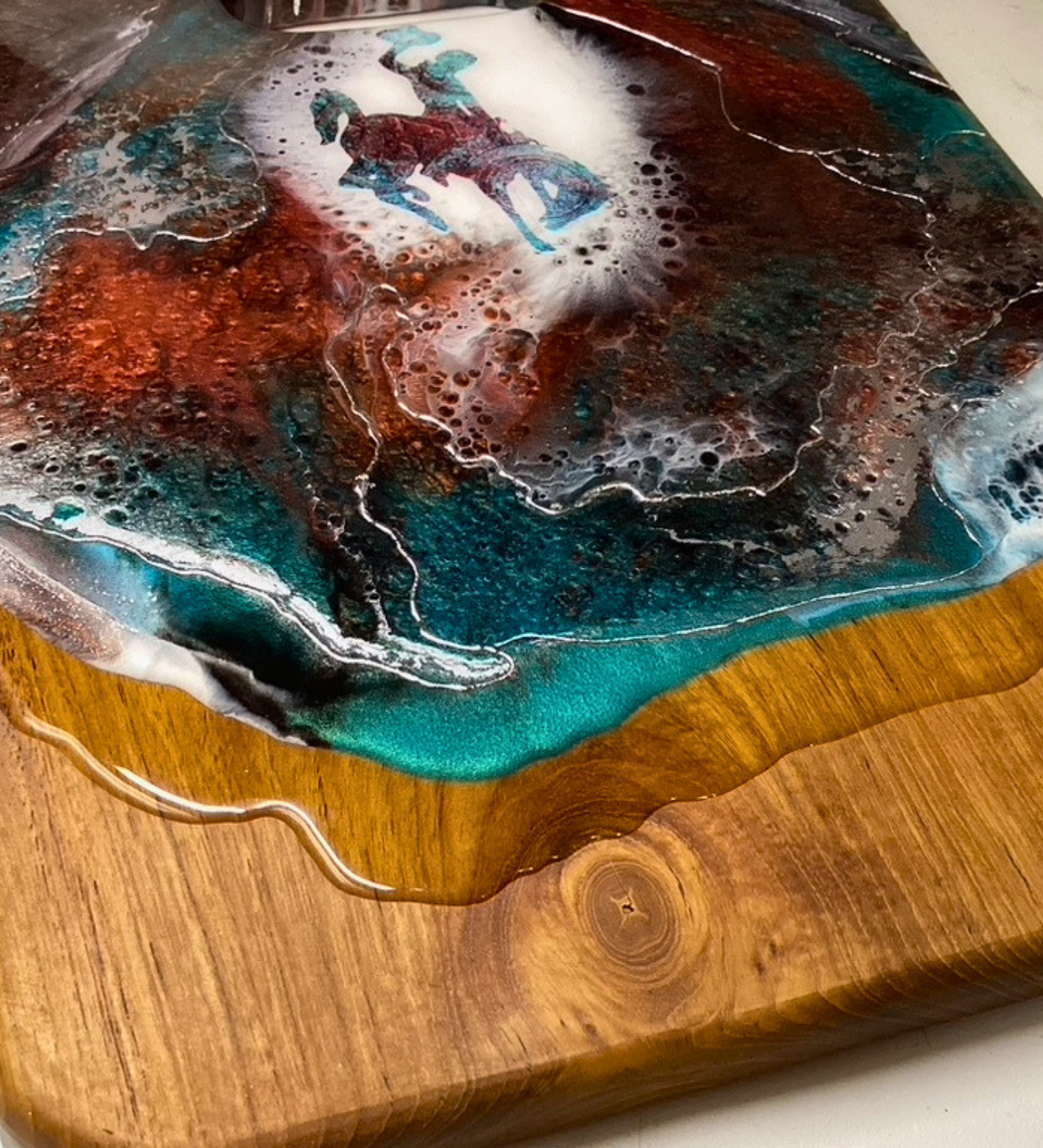 Handmade teak charcuterie board with Wyoming Cowboy design, copper and teal resin artwork, and 24K gold accents