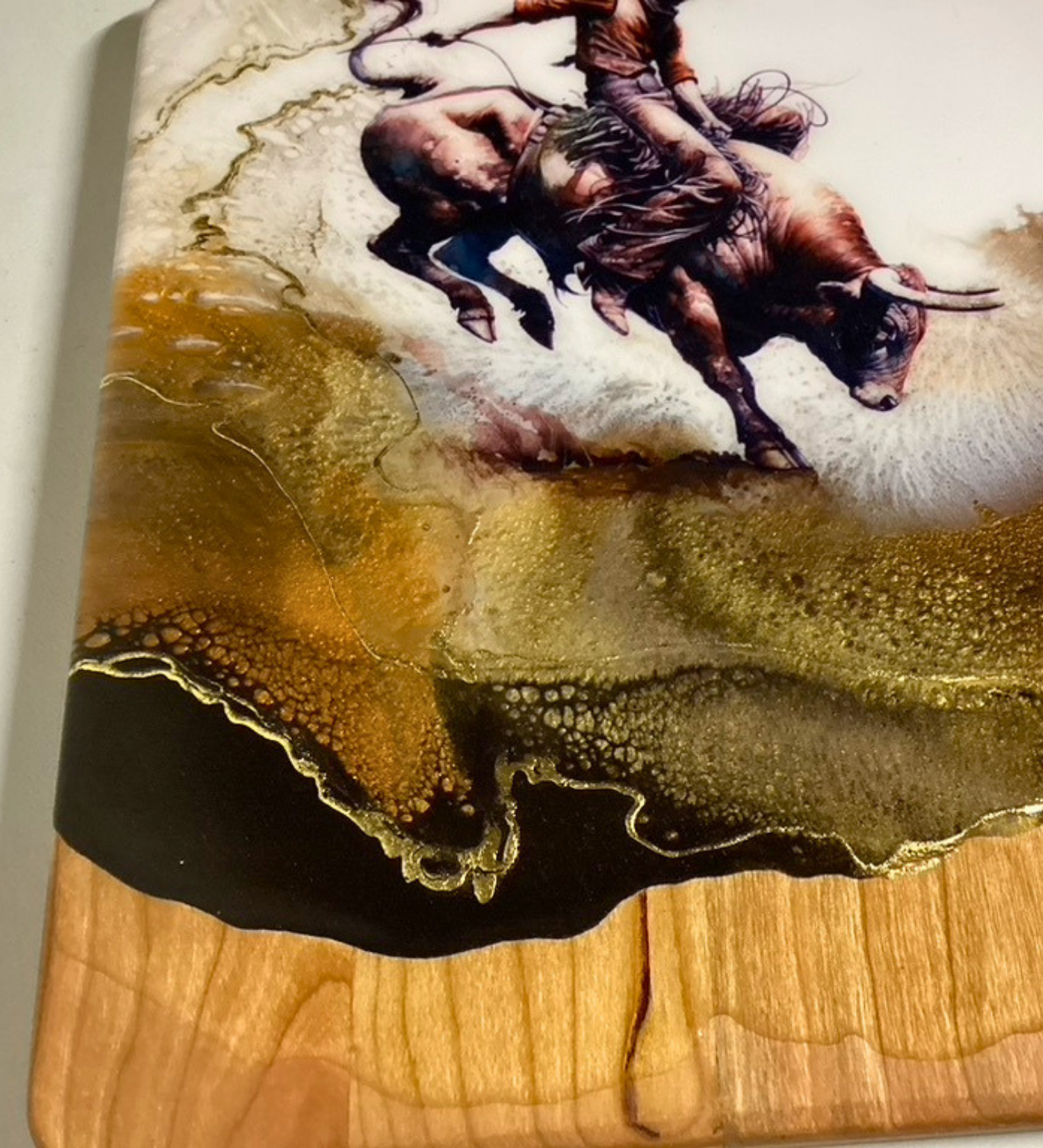 Handmade western charcuterie board featuring bull rider artwork with gold resin accents on natural wood