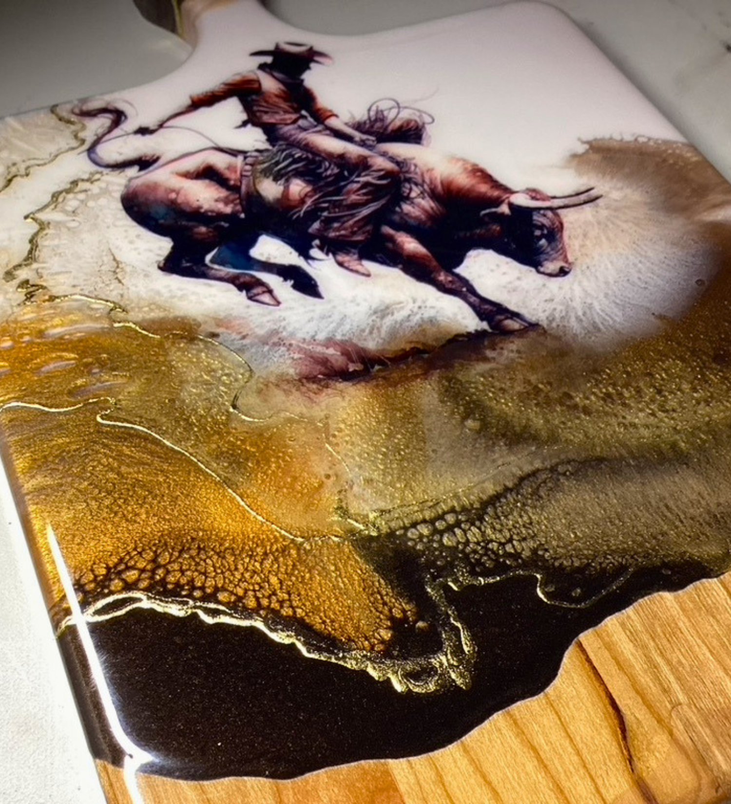Close-up of 24k gold resin detail on handmade western charcuterie board