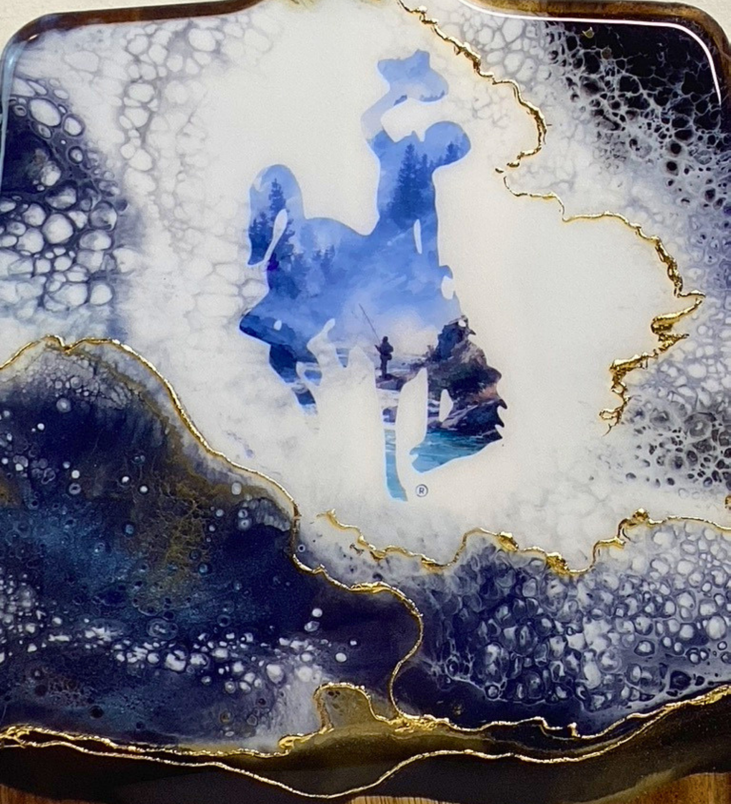 Handmade Wyoming charcuterie board with fly fisherman scene, resin art, and 24K gold accents on acacia wood