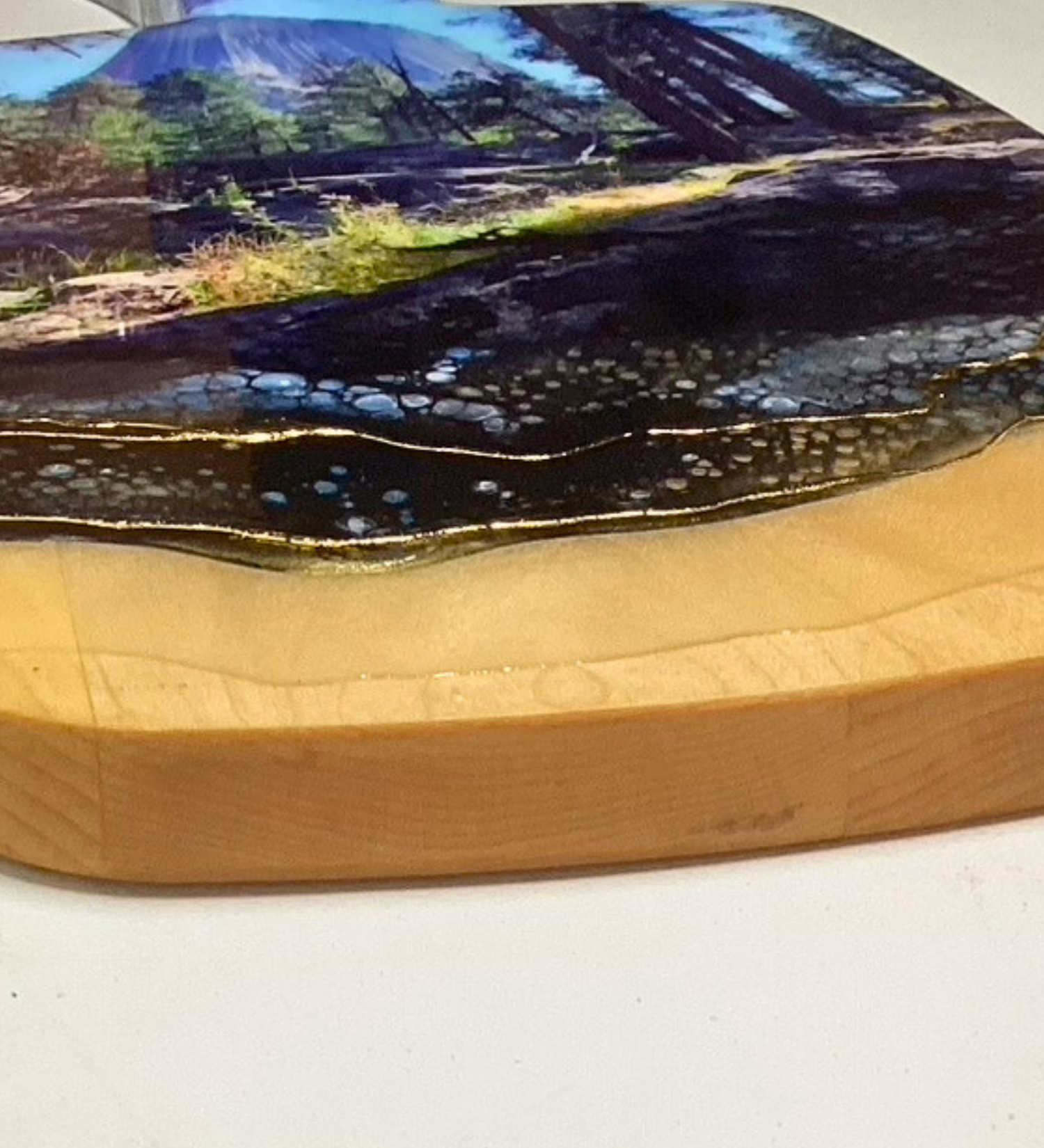 Handcrafted devils tower Wyoming charcuterie board with black and blue resin artwork on maple hardwood serving board.
